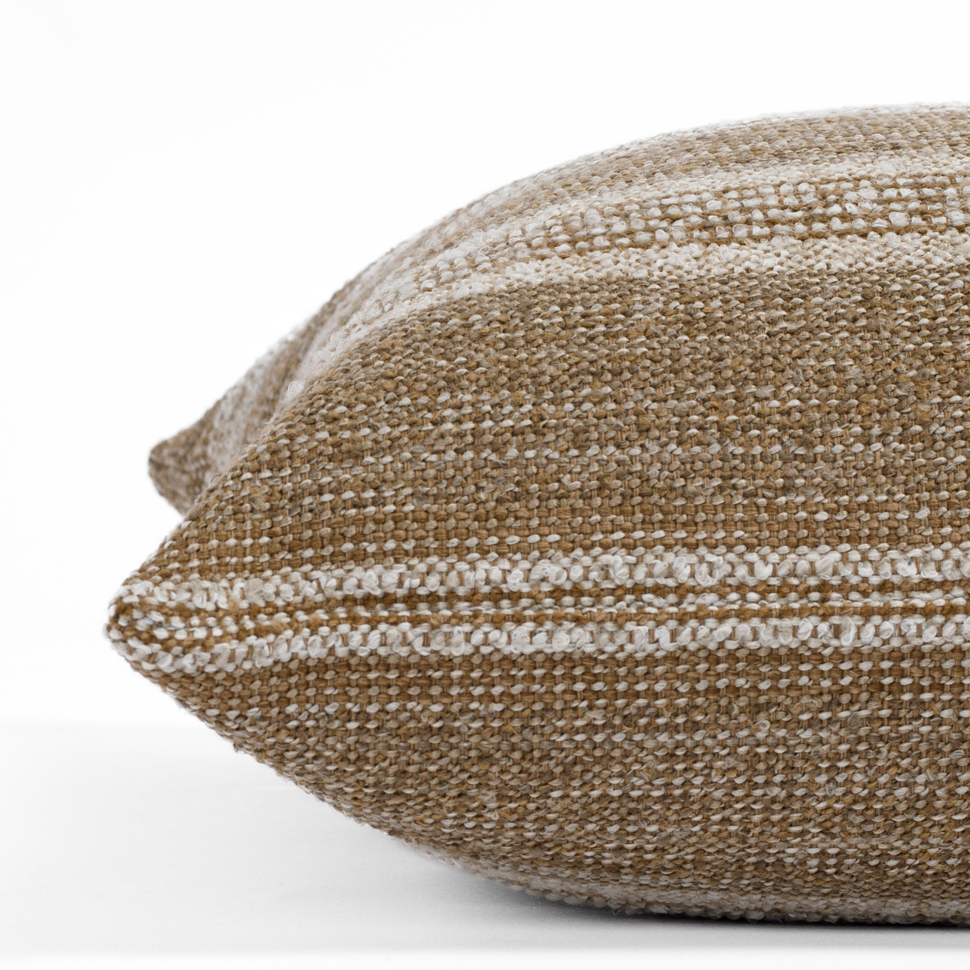 Acadia Cinnamon, a light brown and cream striped throw pillow from Tonic Living: close up side view.