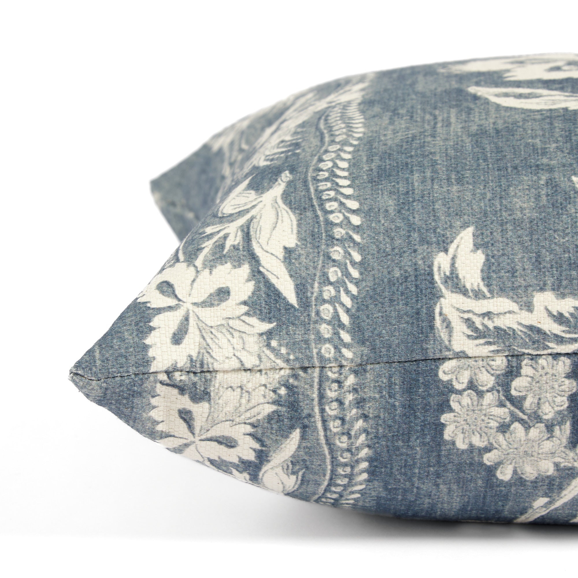 Side view of Tonic Living Ashford decorative cushion highlighting its blue and white botanical vine design.