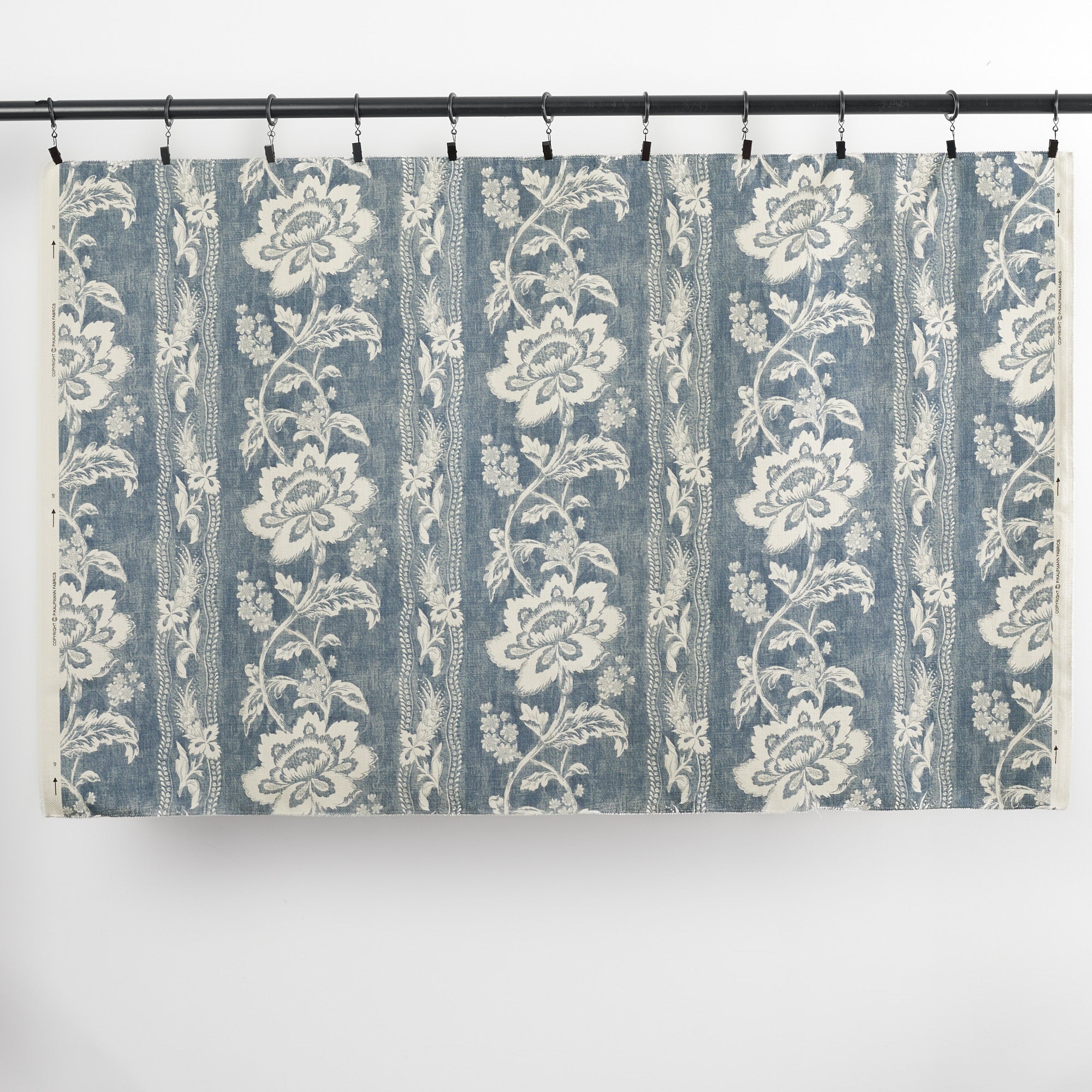 Full yard of Tonic Living Ashford Denim upholstery fabric showing chambray blue floral stripe design.