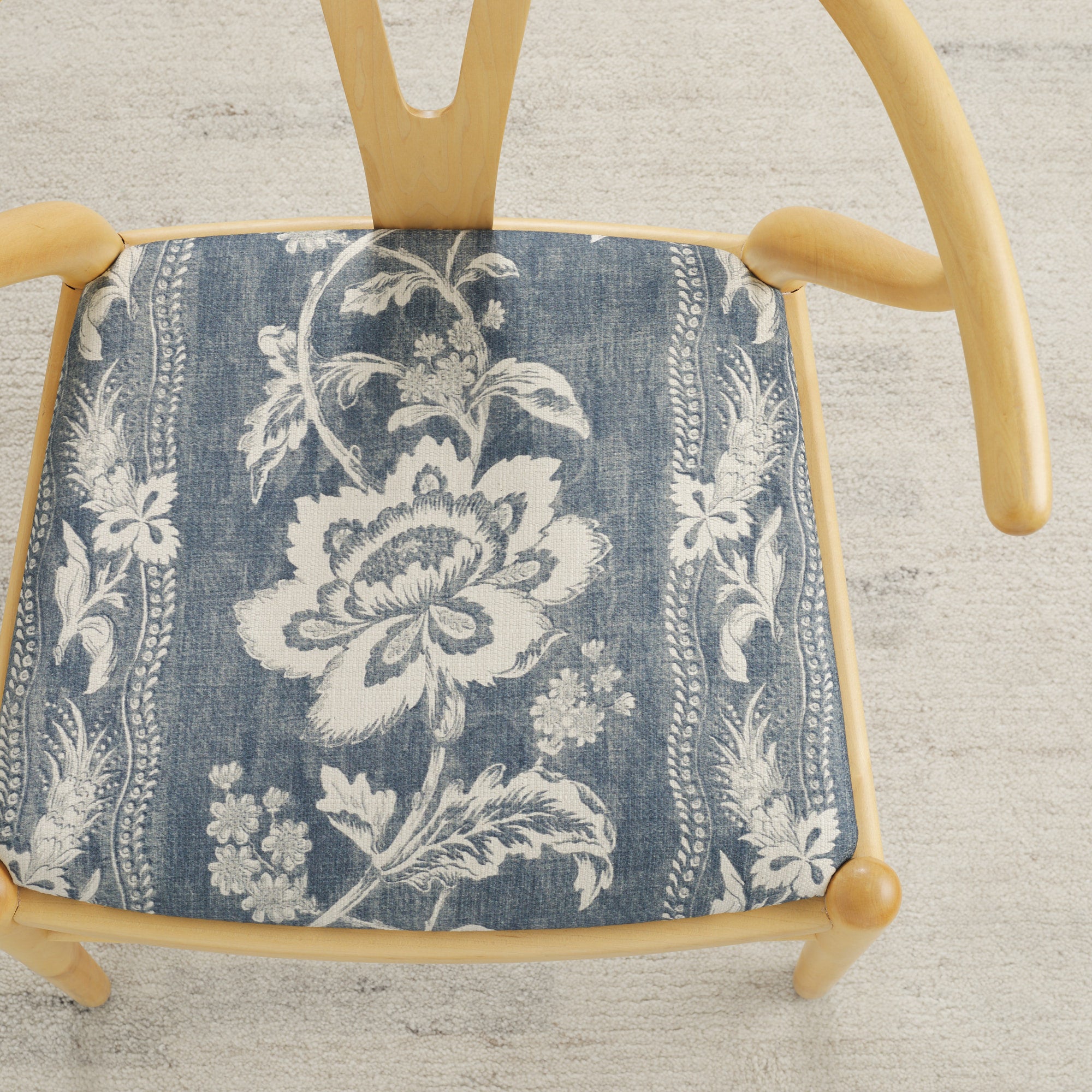 Tonic Living Ashford Denim upholstery fabric on a dining chair seat in blue and white floral stripe.