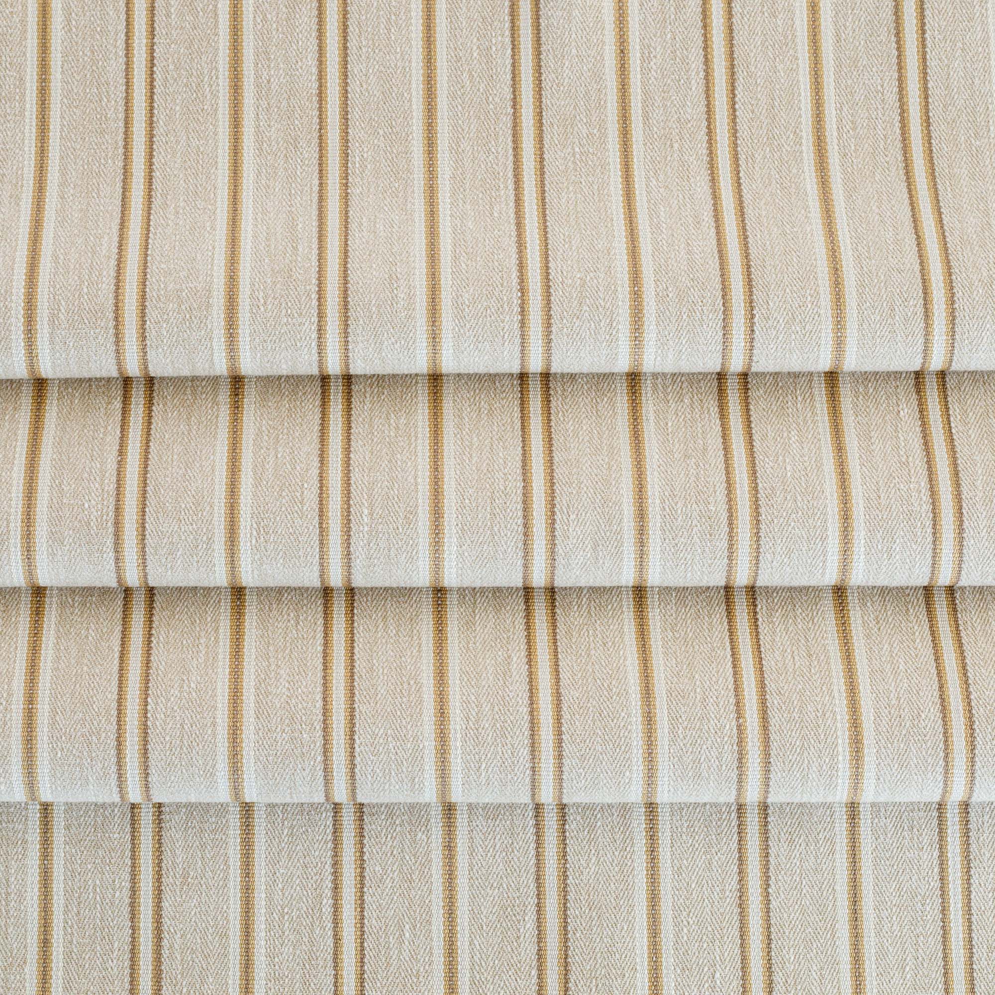 a beige, cream, ochre yellow and tan brown striped upholstery fabric from Tonic Living