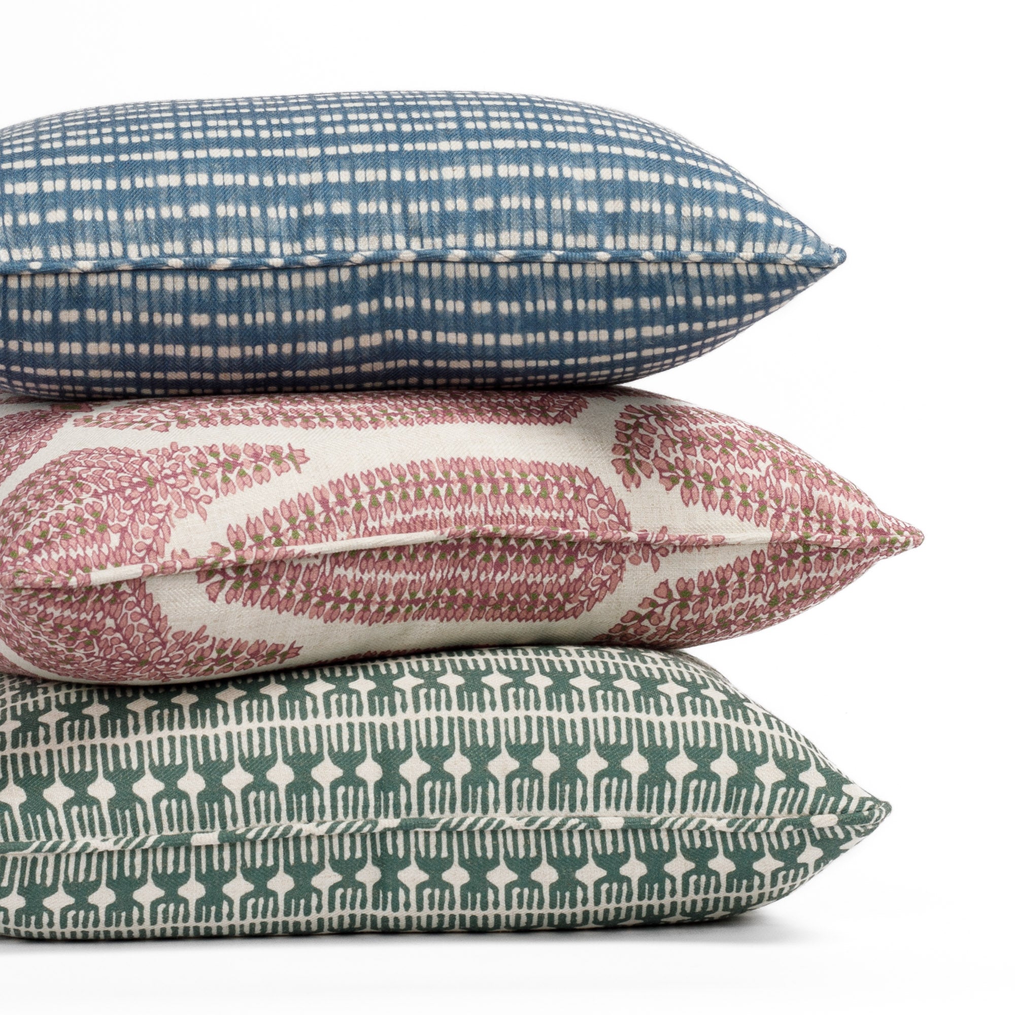 Stack of three pillows from the Bombay Collection by Tonic Living: Meadow Emerald (20x20) on the bottom, Georgia Orchid Pink (20x20) in the middle, and Nile Indigo (14x20 lumbar) on top.