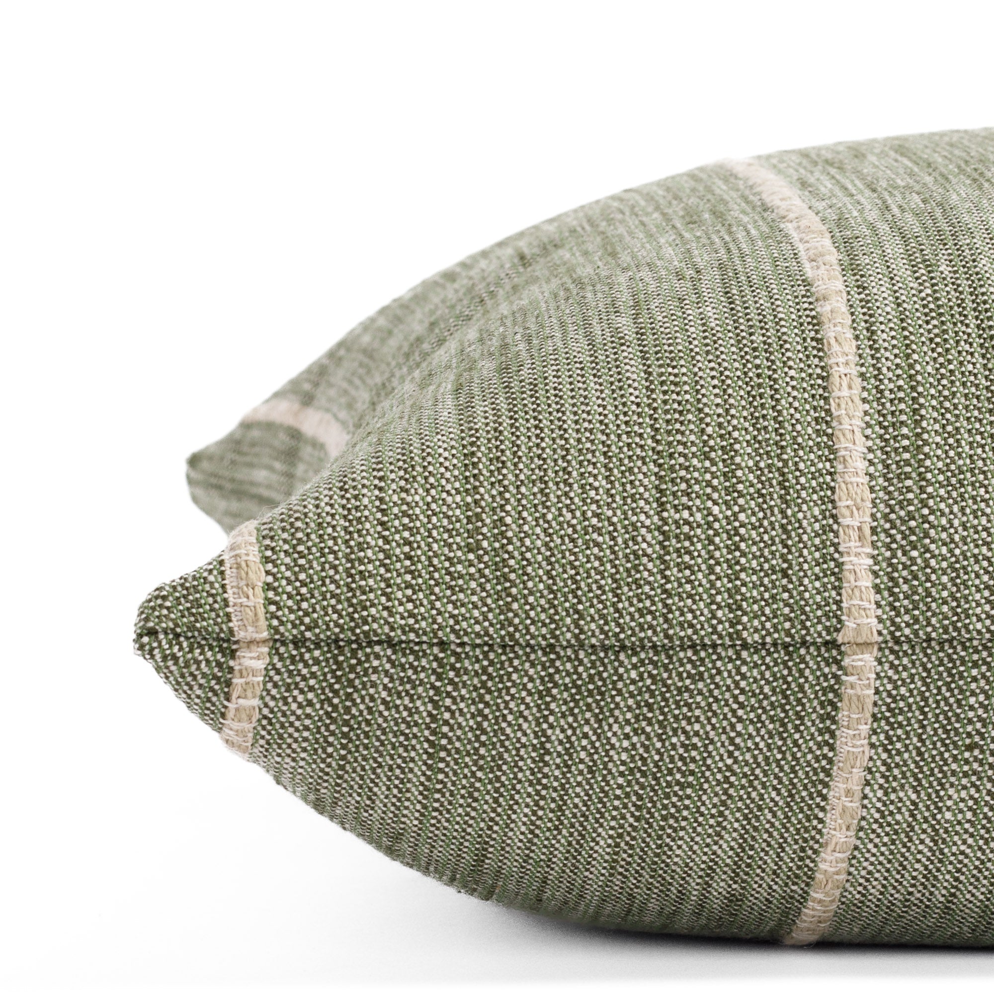 a leafy green throw pillow with a chunky natural stripe: close up side view