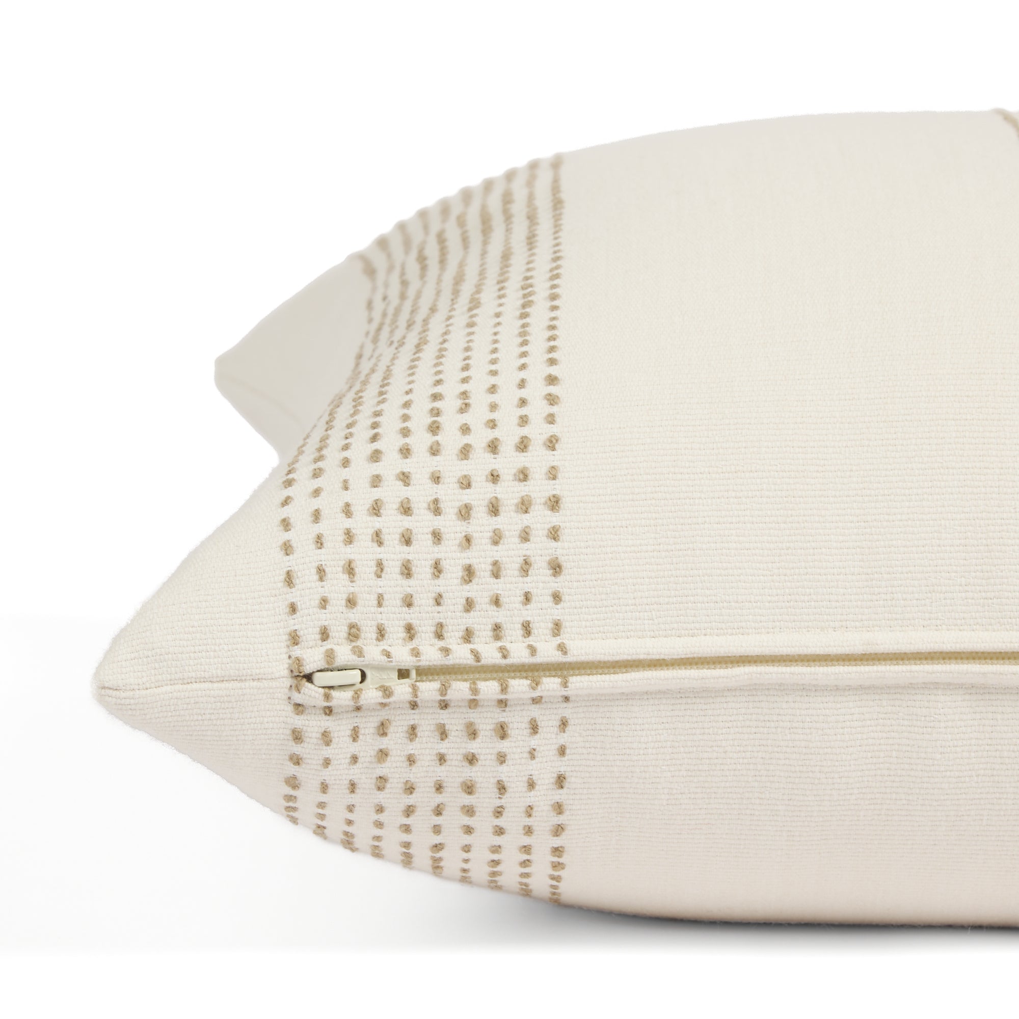 Side zipper detail of Tonic Living Caper 22x22 outdoor toss pillow in a neutral off-white and tan stripe.