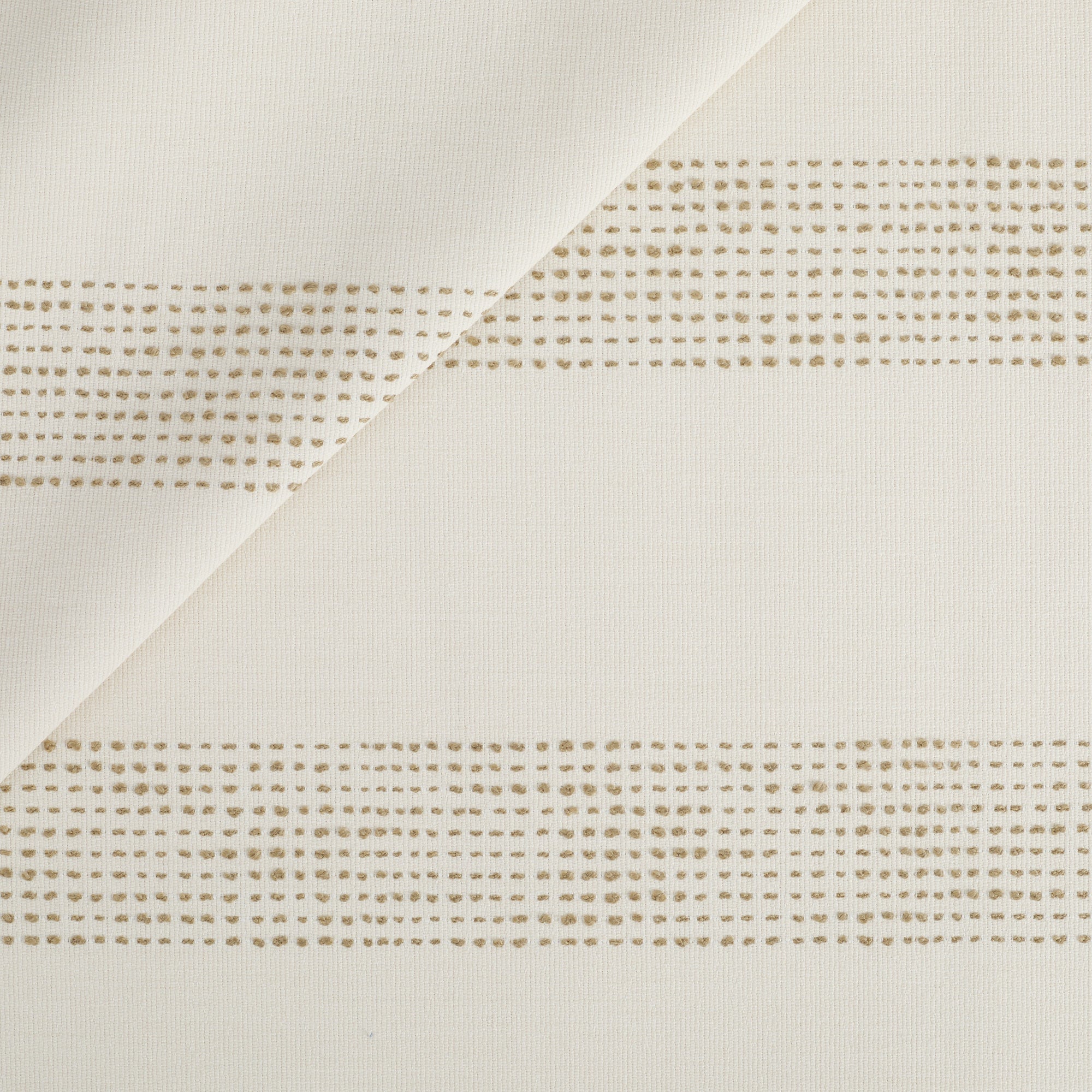 Tonic Living Caper Sunbrella Outdoor Fabric in Linen, a creamy white indoor/outdoor upholstery fabric with dotted stripe.