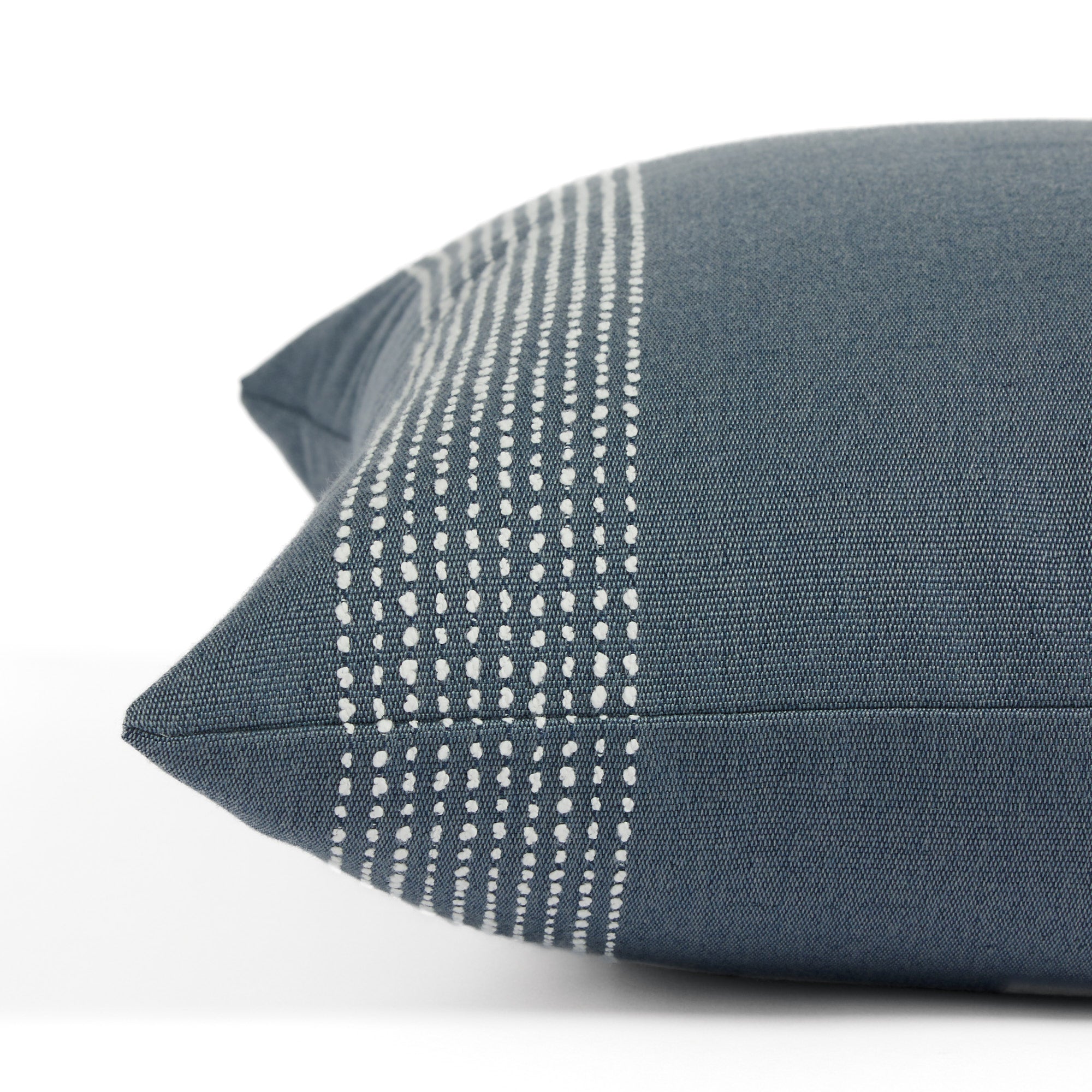 Side view of Tonic Living Caper Slate decorative cushion highlighting its textured banded stripe design.