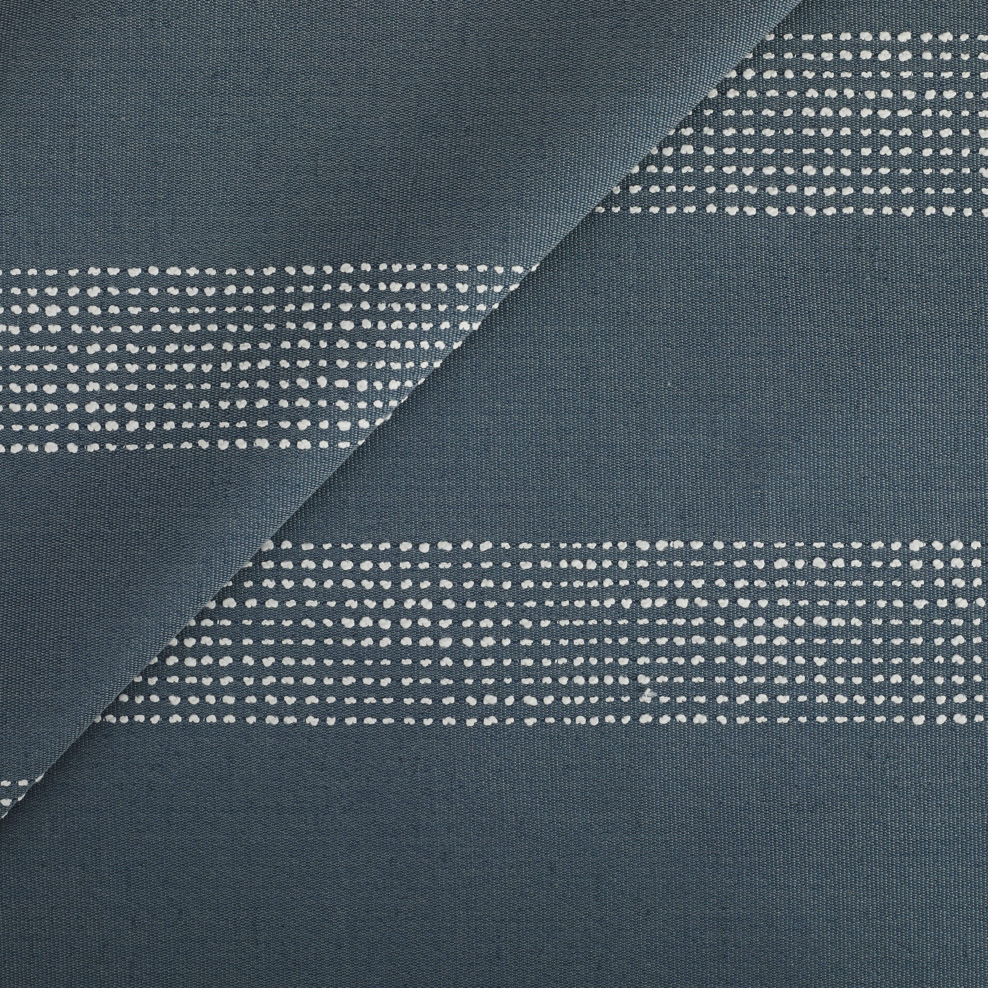 Tonic Living Caper Sunbrella Outdoor Fabric in Slate, a slate blue indoor/outdoor upholstery fabric with dotted stripe.