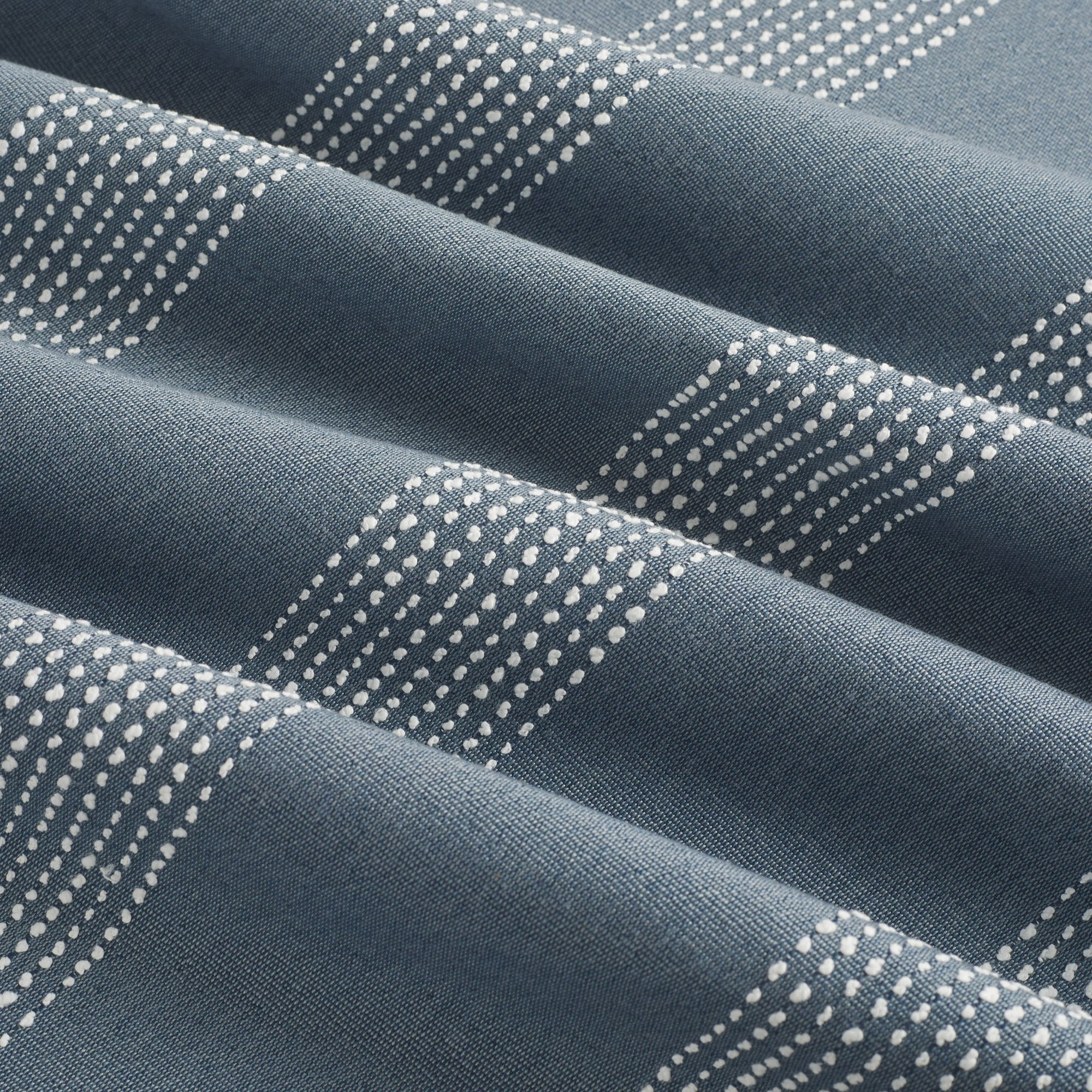 Tonic Living Caper Sunbrella Slate indoor/outdoor upholstery fabric with soft banded stripe in slate blue and white.