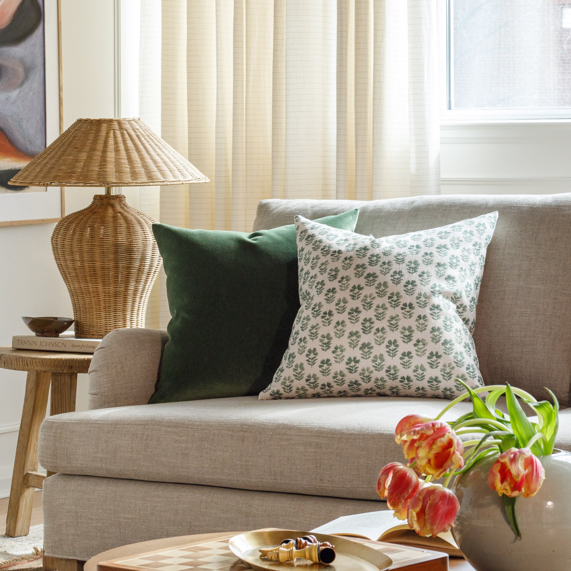 Beautiful green designer throw pillows from Tonic Living, styled in a living room.