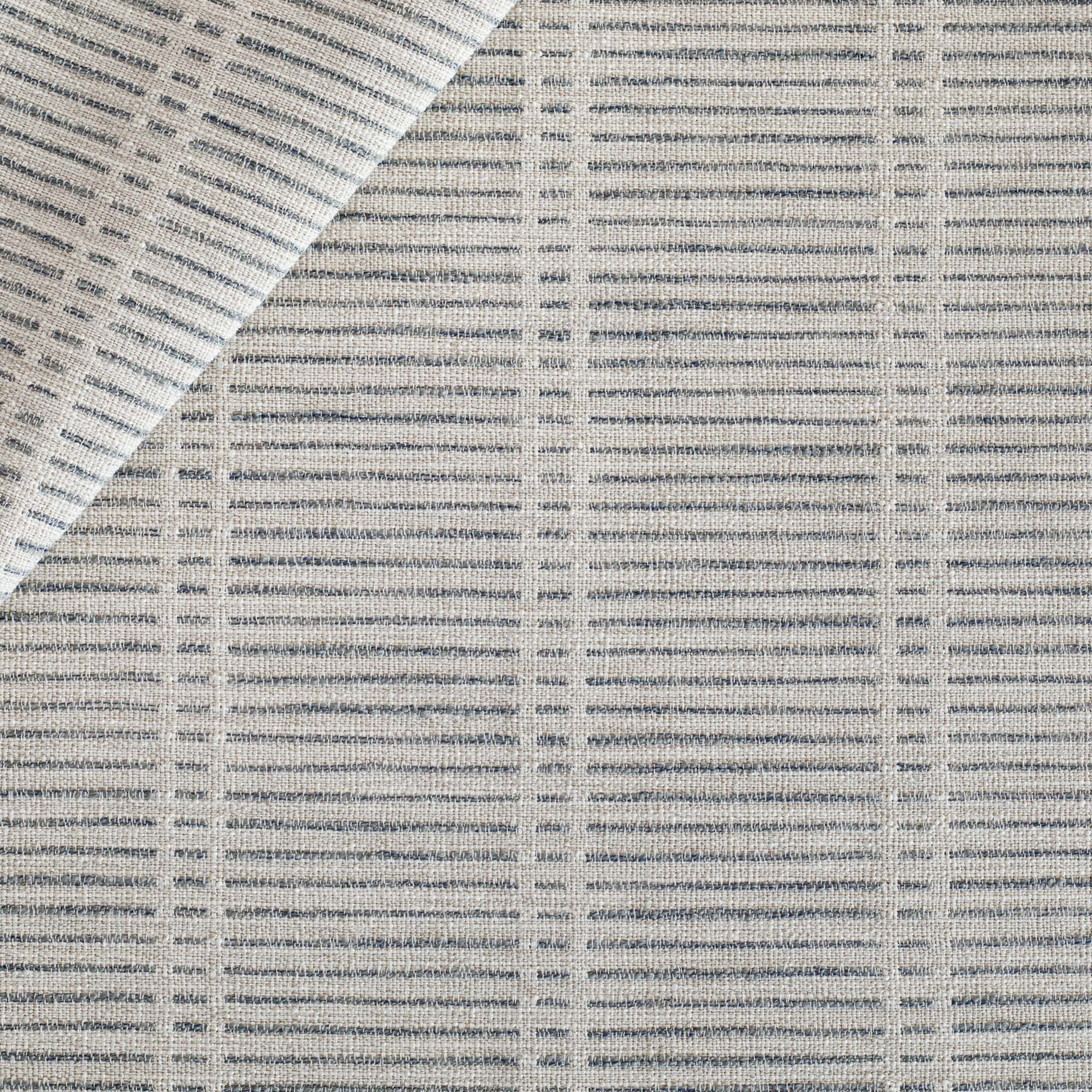 a woven light grey and stone blue dashed stripe patterned upholstery fabric