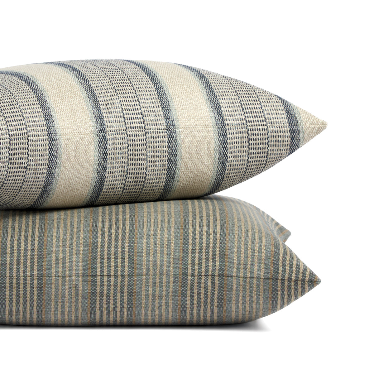 Stack of Tonic Living Clark Stripe and Miller Stripe pillows featuring layered blue and neutral striped patterns.