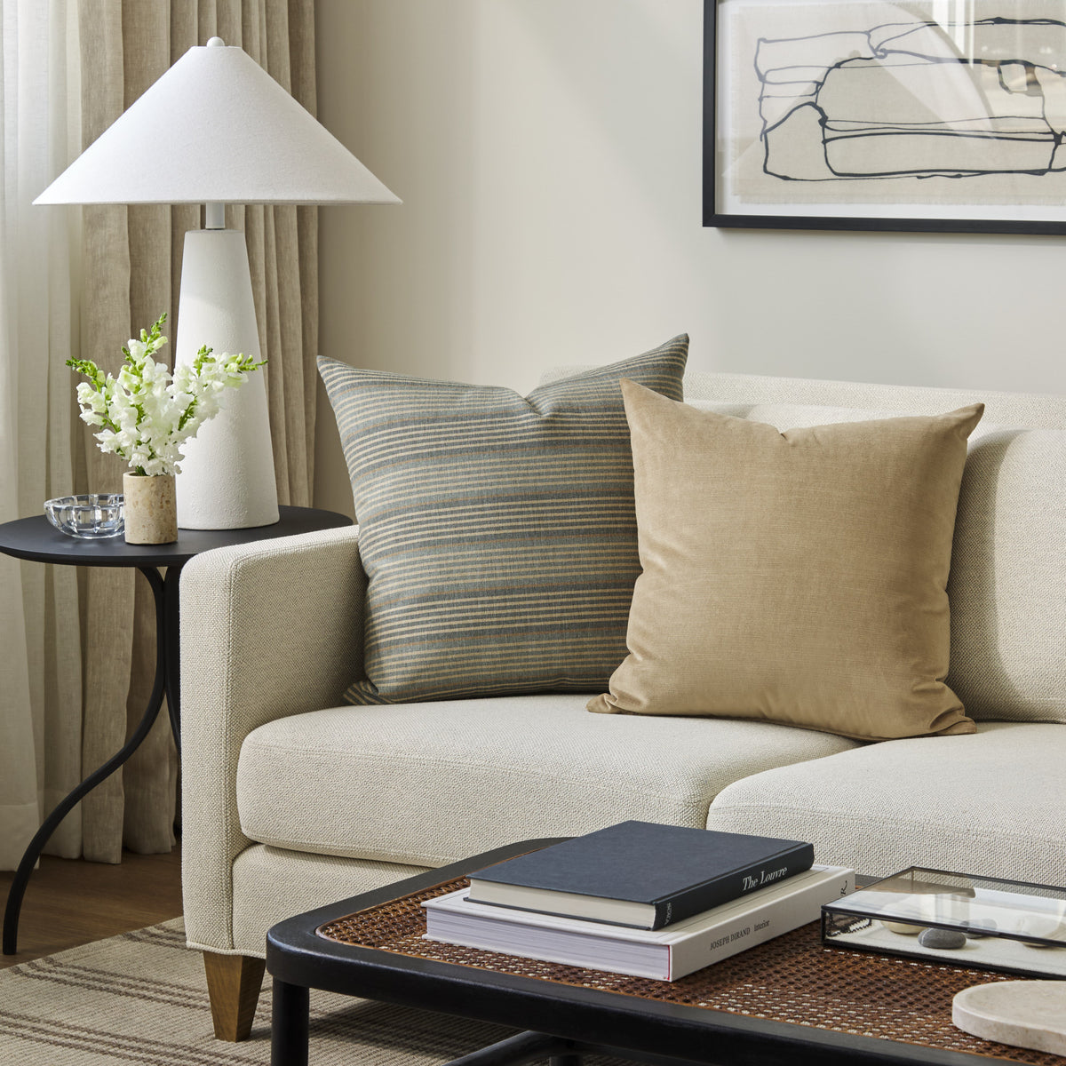 Tonic Living Sterling Velvet Bark decorative cushion styled on a sofa with a coordinating blue striped throw pillow.