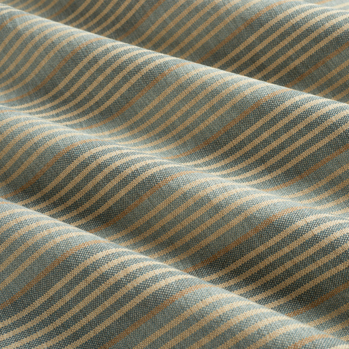 Tonic Living Clark Stripe Pool performance upholstery fabric featuring a multi-stripe pattern in faded blue and warm neutrals.