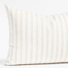 a soft white and beige stripe lumbar pillow
