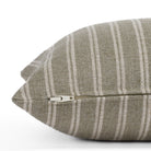Side view of the Conway Stripe Sage 12x24 lumbar cushion by Tonic Living, showing the exposed zipper and slubby weave in dusty sage green and warm beige.
