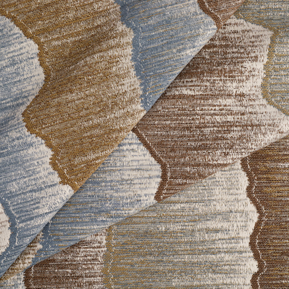 Tonic Living Cortina Storm woven jacquard fabric featuring layered abstract shapes in rich blue, brown, and neutral tones.