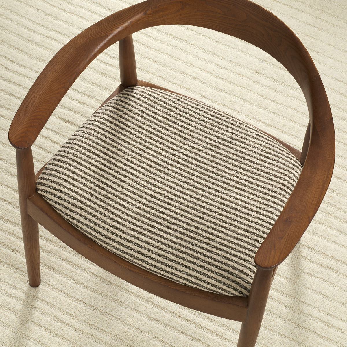 Tonic Living Crosby Stripe Truffle high-performance fabric shown upholstered on a dining chair seat with a neutral brown stripe.