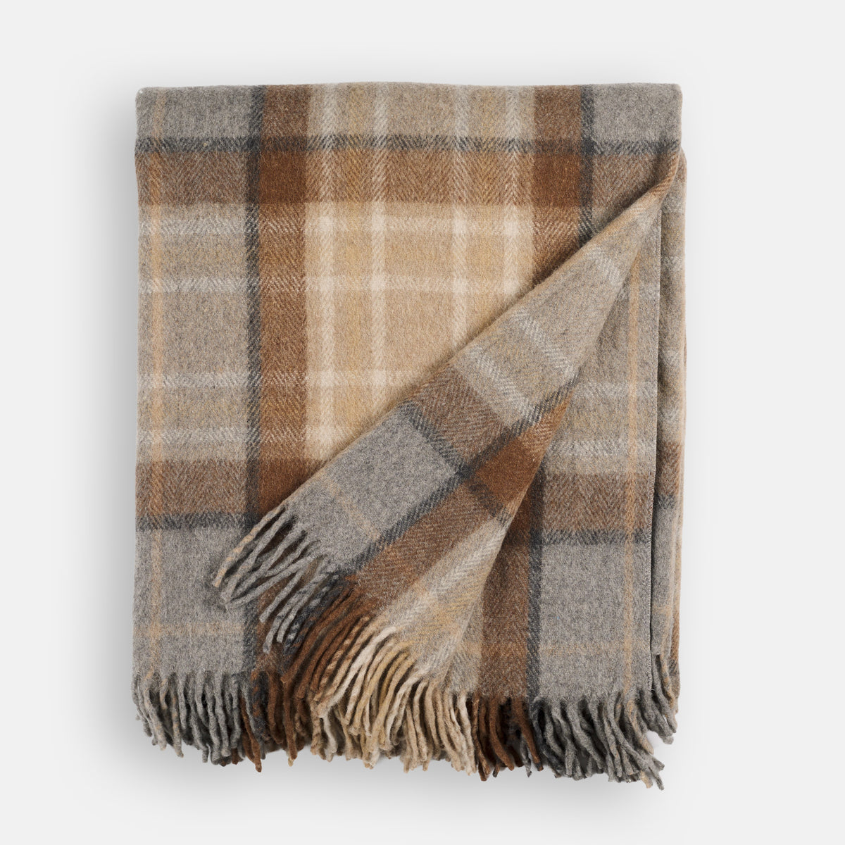 Folded Tonic Living Duncan Plaid Wool Throw Blanket in Tweed featuring a classic brown, camel, and grey plaid pattern.