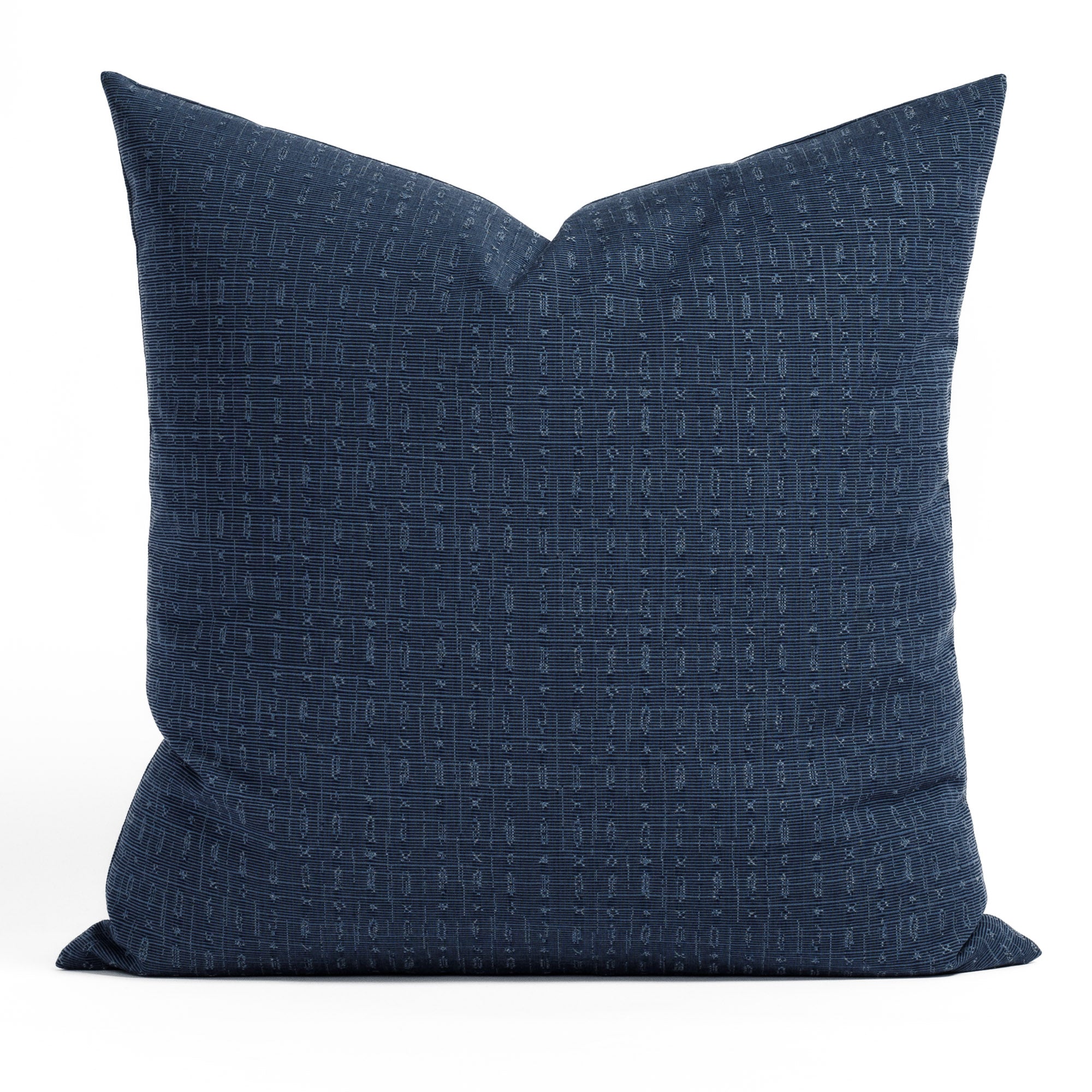 Embrace Indigo 22x22 Indoor/Outdoor Pillow from Tonic Living, a navy tone-on-tone texture with a subtle abstract geometric design.