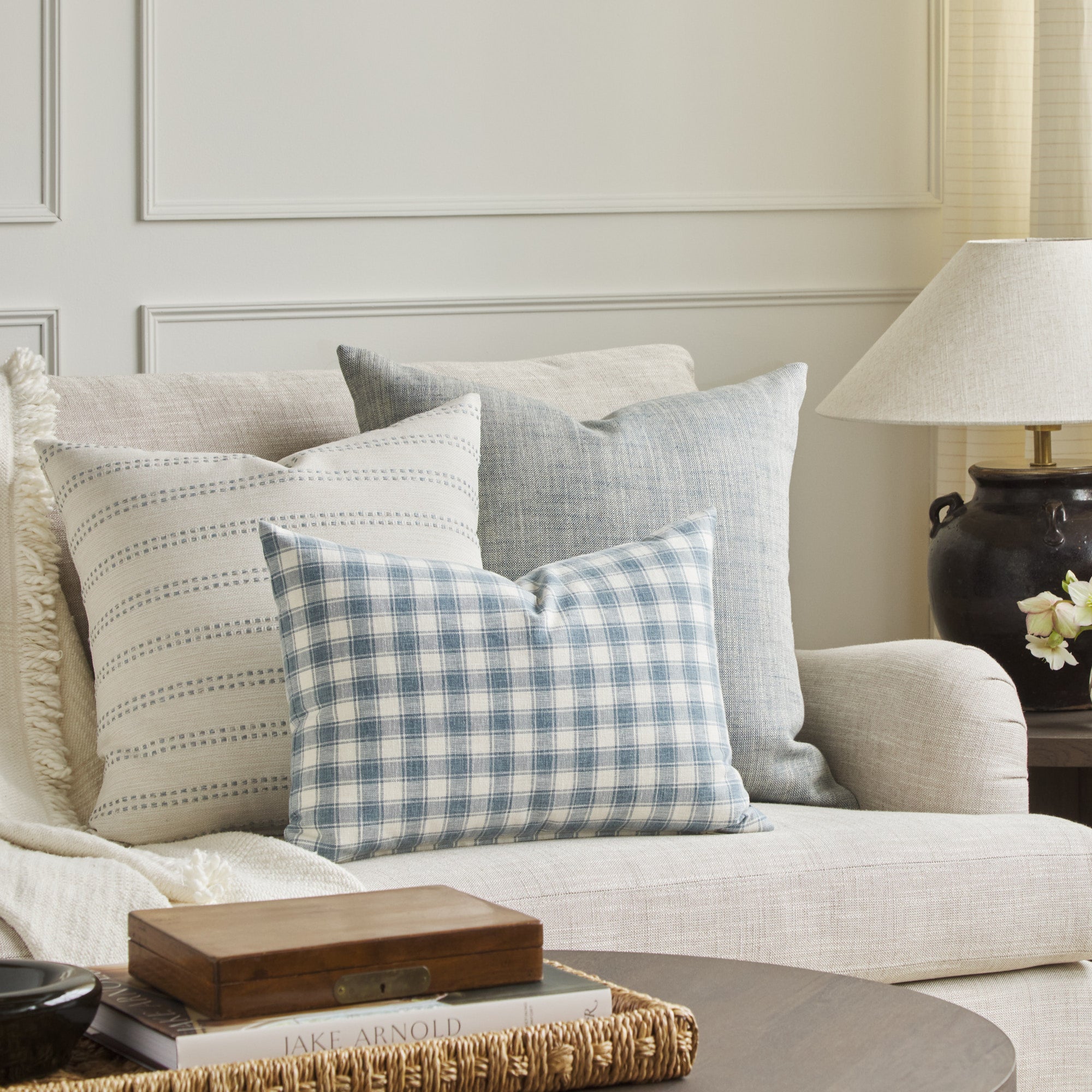 Tonic Living Emmett Plaid blue lumbar cushion styled with Elodie Stripe 20x20 Pillow in Sky and Brussels 22x22 Pillow in Sky.