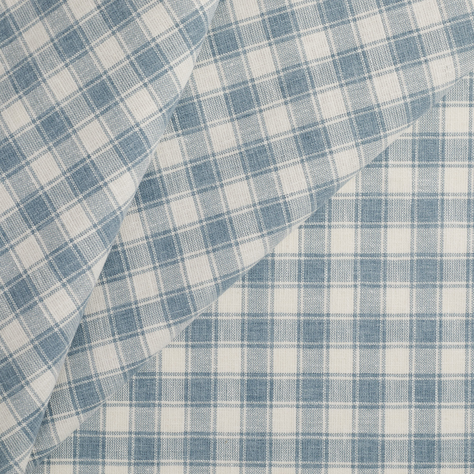Tonic Living Emmett Plaid Fabric in Denim Blue, a small-scale blue and white check upholstery fabric.