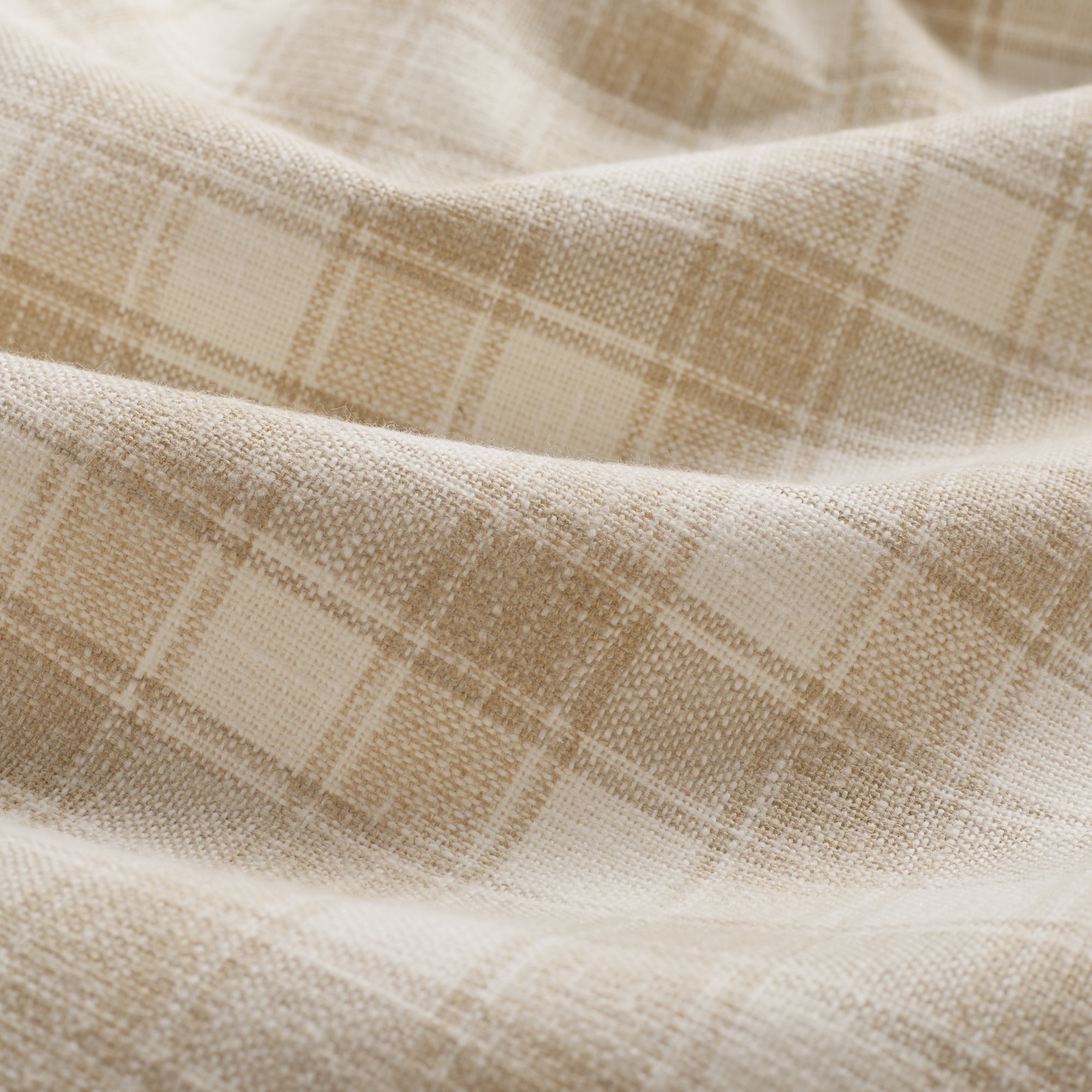 Close up of Tonic Living Emmett Plaid Flax fabric featuring a timeless small-scale plaid in warm neutral tones.