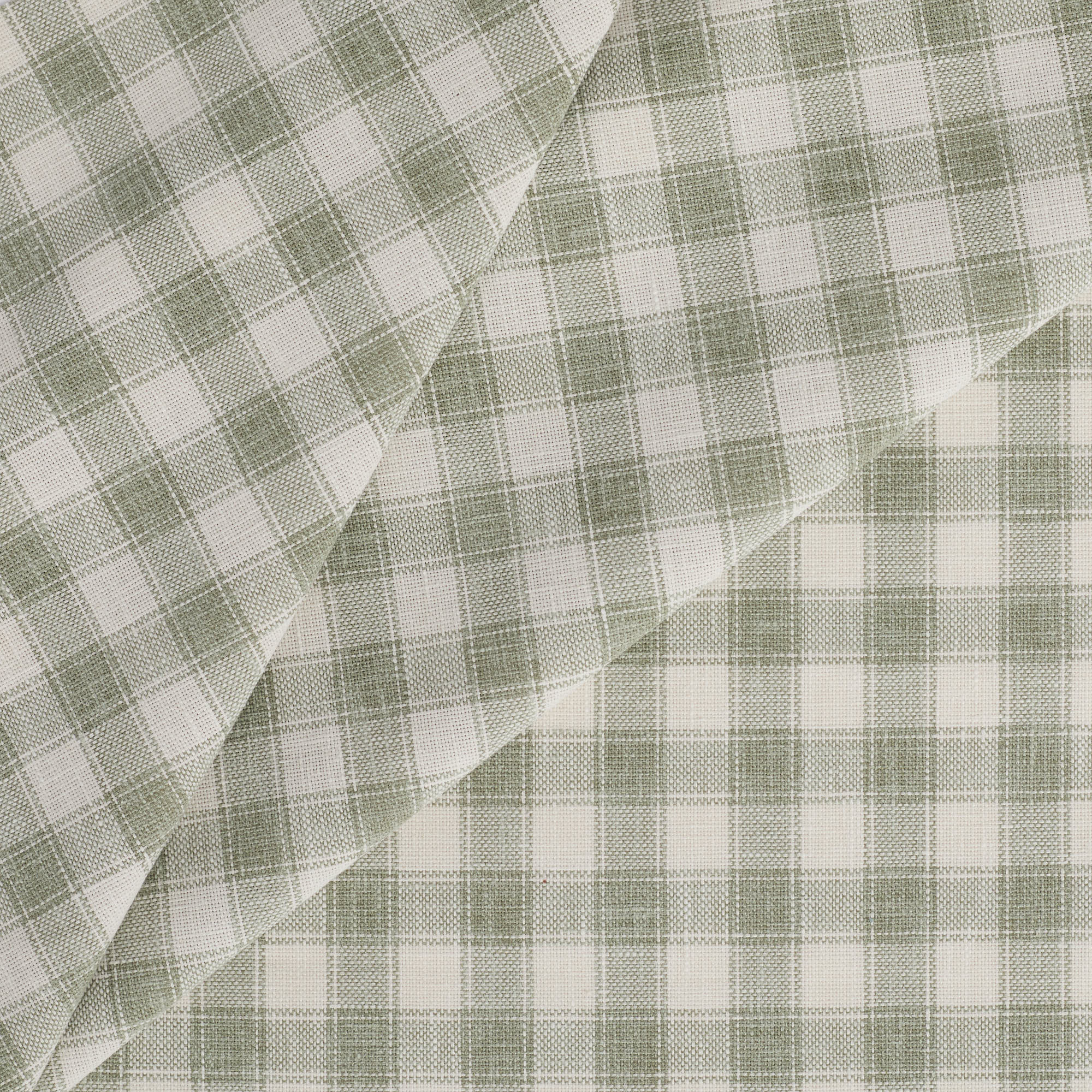 Tonic Living Emmett Plaid Fabric in Sage, a small-scale green and white check upholstery fabric.