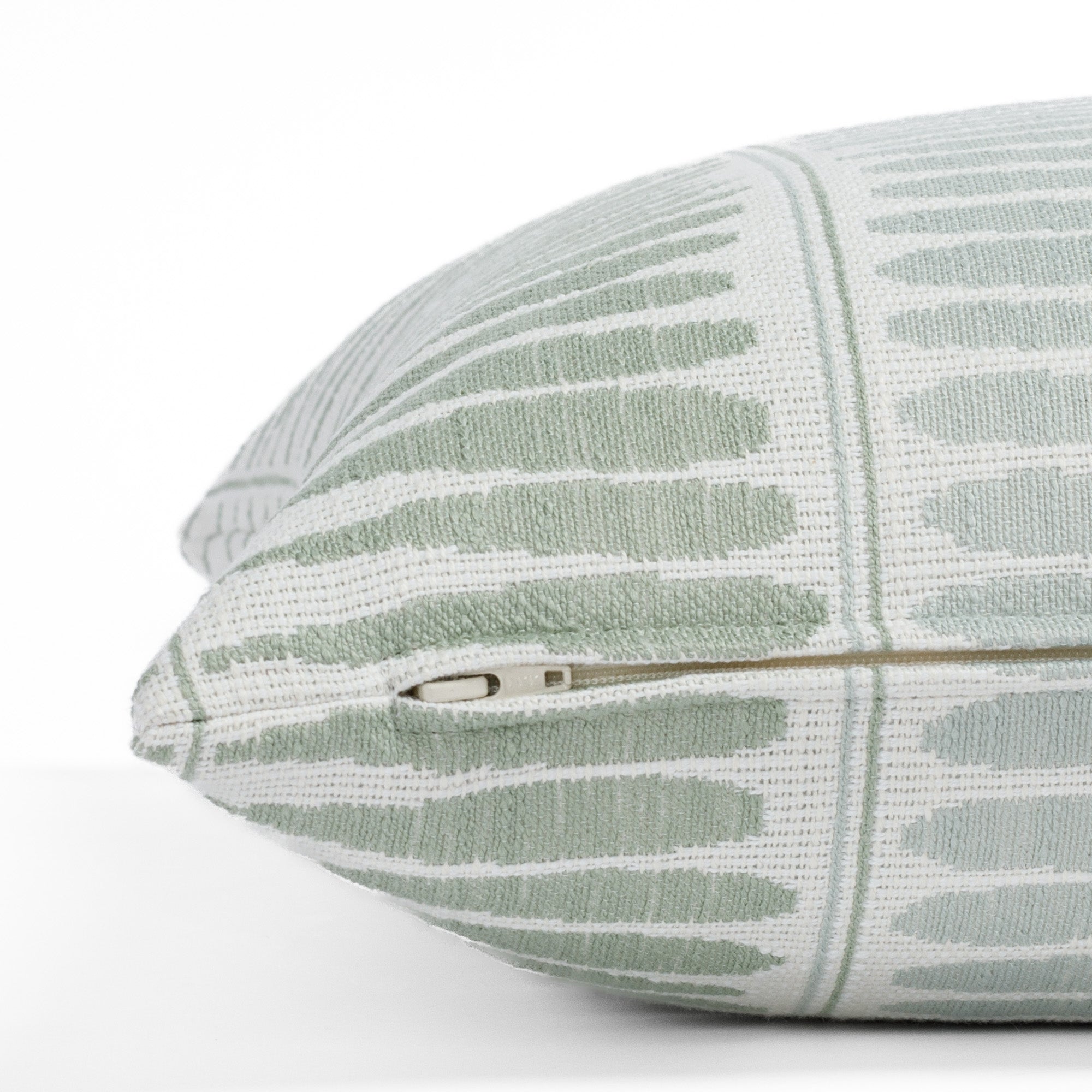 Everly Jade 20x20, a soft green, pale seafoam and white indoor/outdoor pillow from Tonic Living: close-up zipper view.