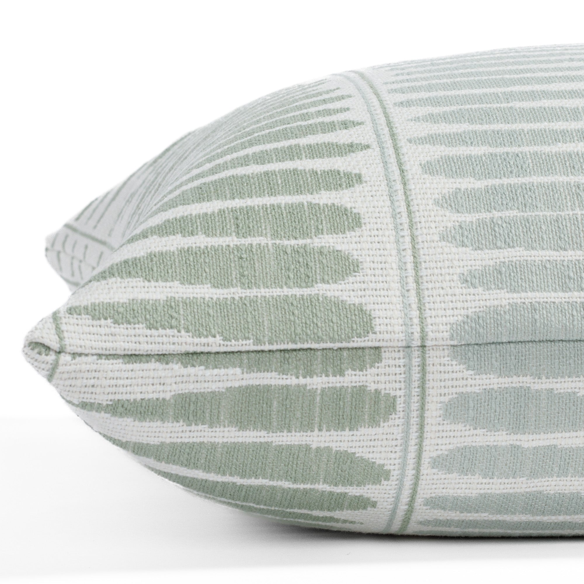 Everly Jade 20x20 indoor/outdoor pillow from Tonic Living, featuring a frosted aqua and celadon green botanical pattern of elongated leaves.