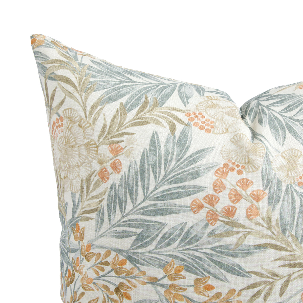 Close up of Tonic Living Fable Meadow pillow showing blue leaves, terracotta blooms, and delicate brown botanical sprigs on soft white.