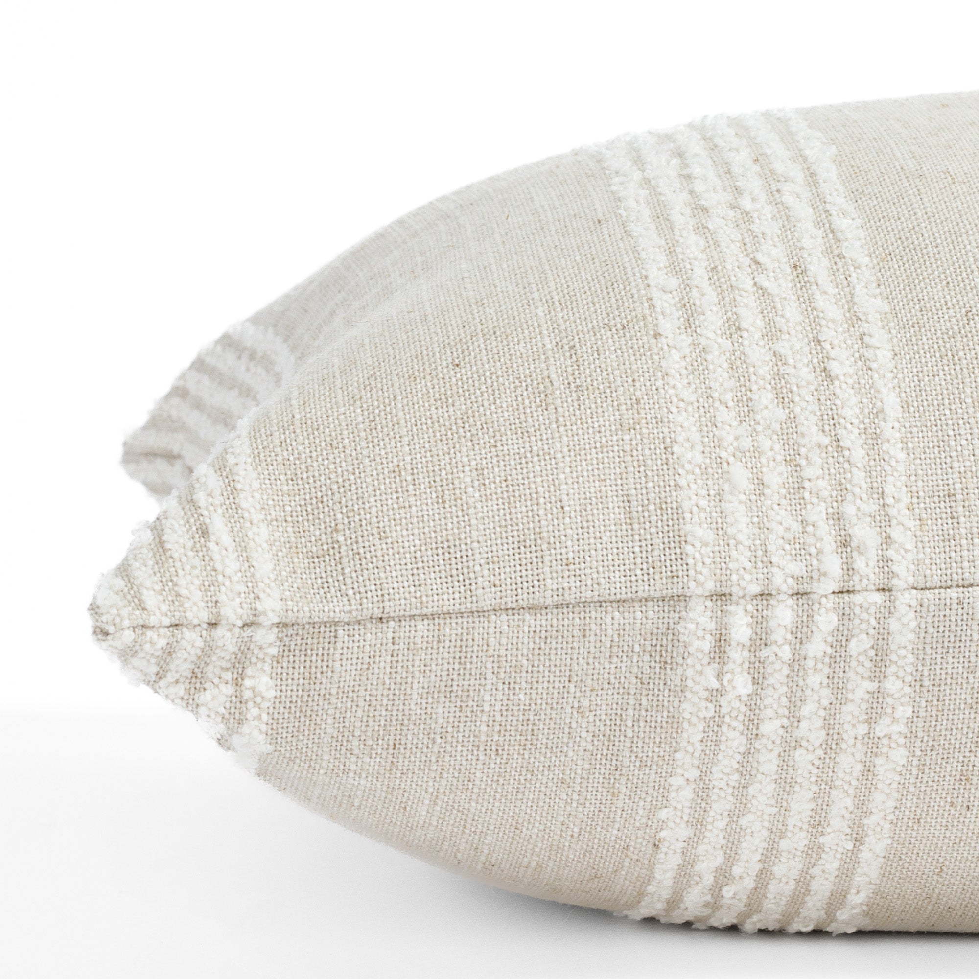 an off white and oatmeal pillow : close up side view