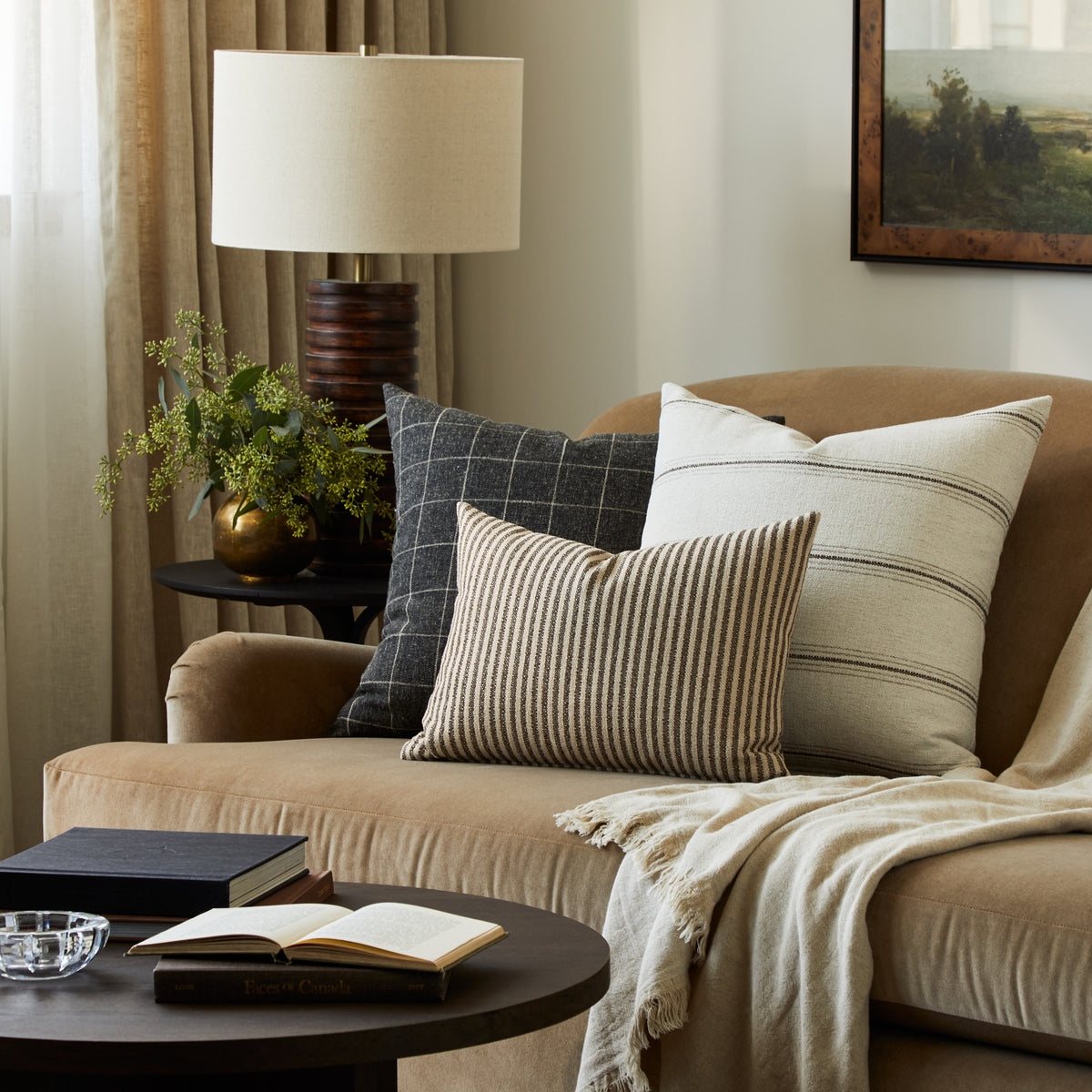 Tonic Living Crosby Stripe Truffle decorative lumbar pillow styled with striped and checked cushions in a neutral living room.