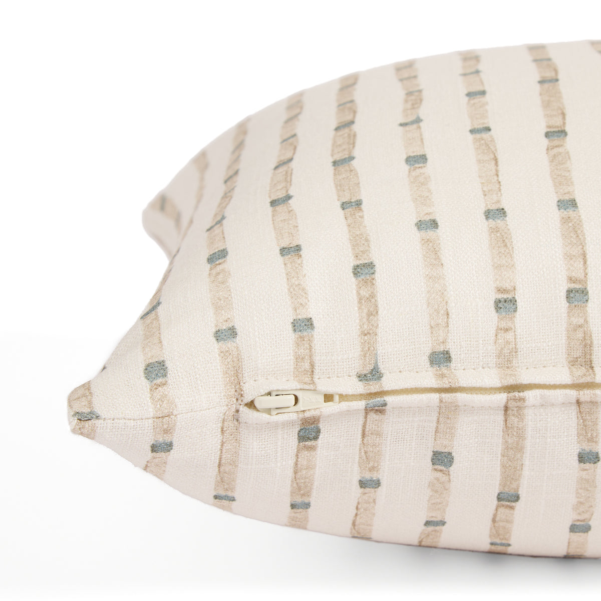 Side zipper detail of Tonic Living Hadley Stripe 14x20 decorative cushion featuring blue and warm brown stripes on off-white.