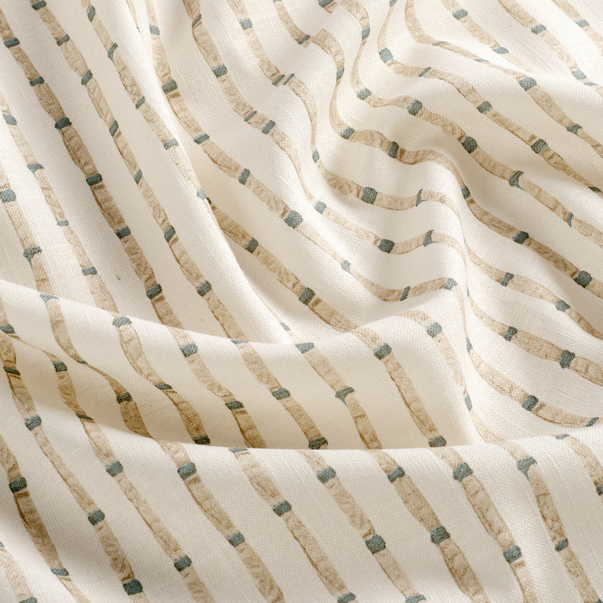 Tonic Living Hadley Stripe curtain fabric featuring a decorative blue and light brown stripe on a soft off-white background.