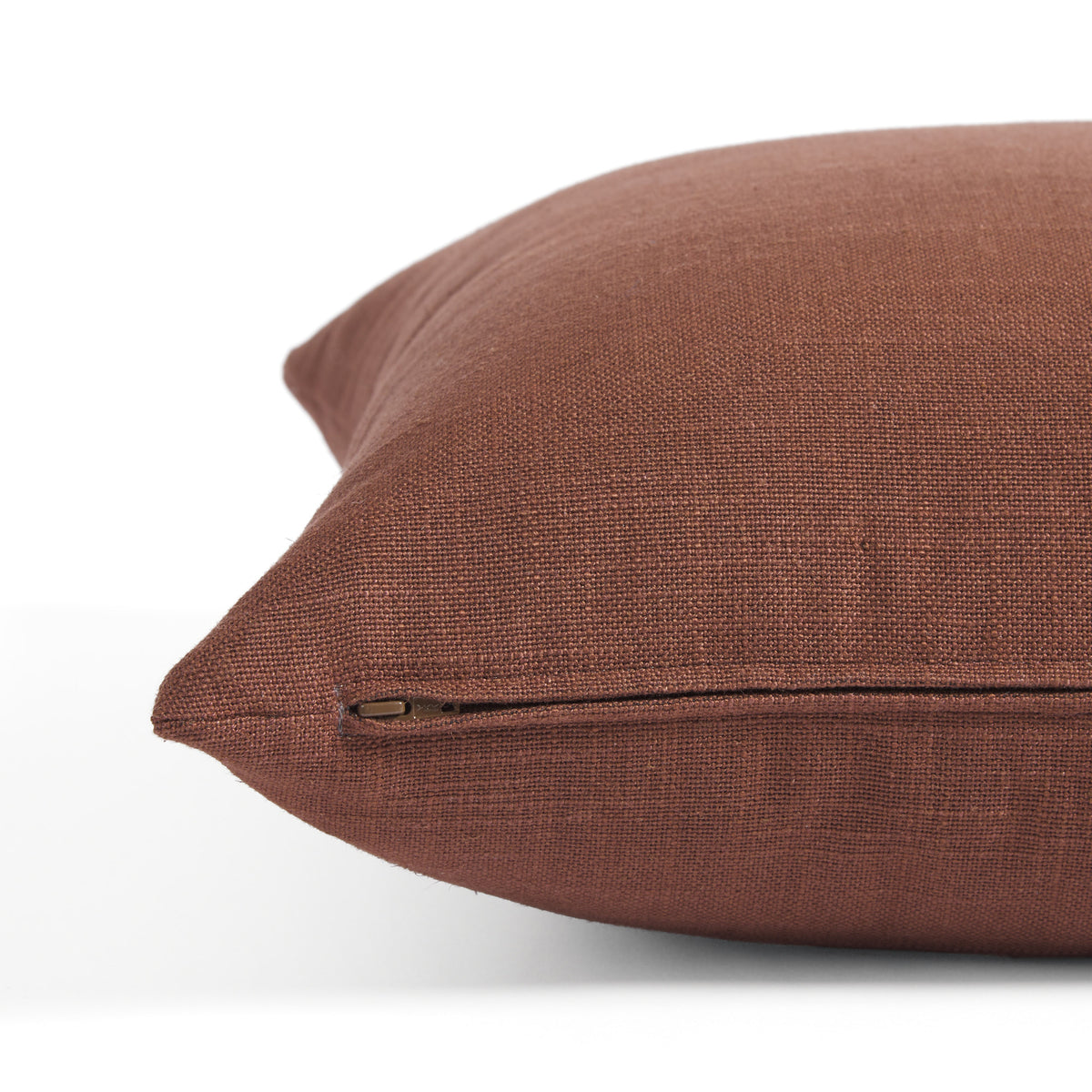 Side zipper detail of Tonic Living Hampton 22x22 pillow in earthy burgundy with a linen-inspired texture.