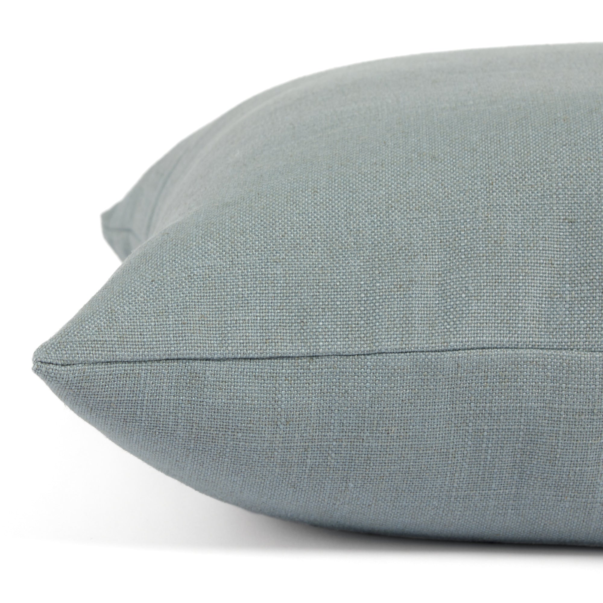 Side view of Tonic Living Hampton Chambray decorative pillow highlighting its chambray blue Belgian linen look.