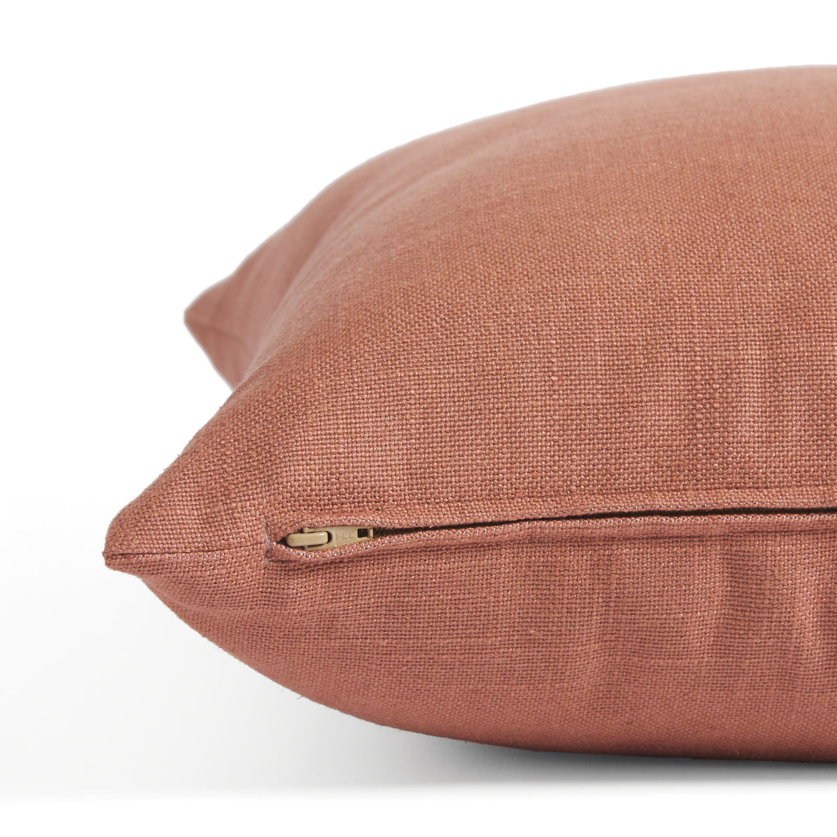 Side zipper detail of Tonic Living Hampton 22x22 pillow in earthy rose pink with a linen-inspired texture.