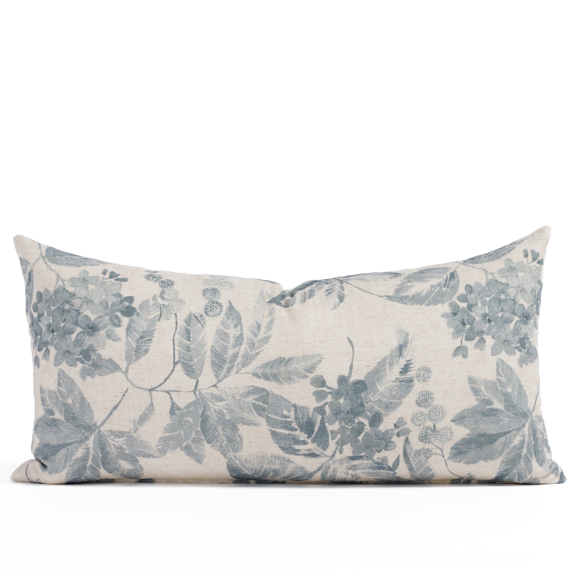 Straight-on shot of the Heather Indigo 12x24 decorative lumbar pillow by Tonic Living, showcasing a romantic floral pattern in washed blue and beige on subtly textured fabric.