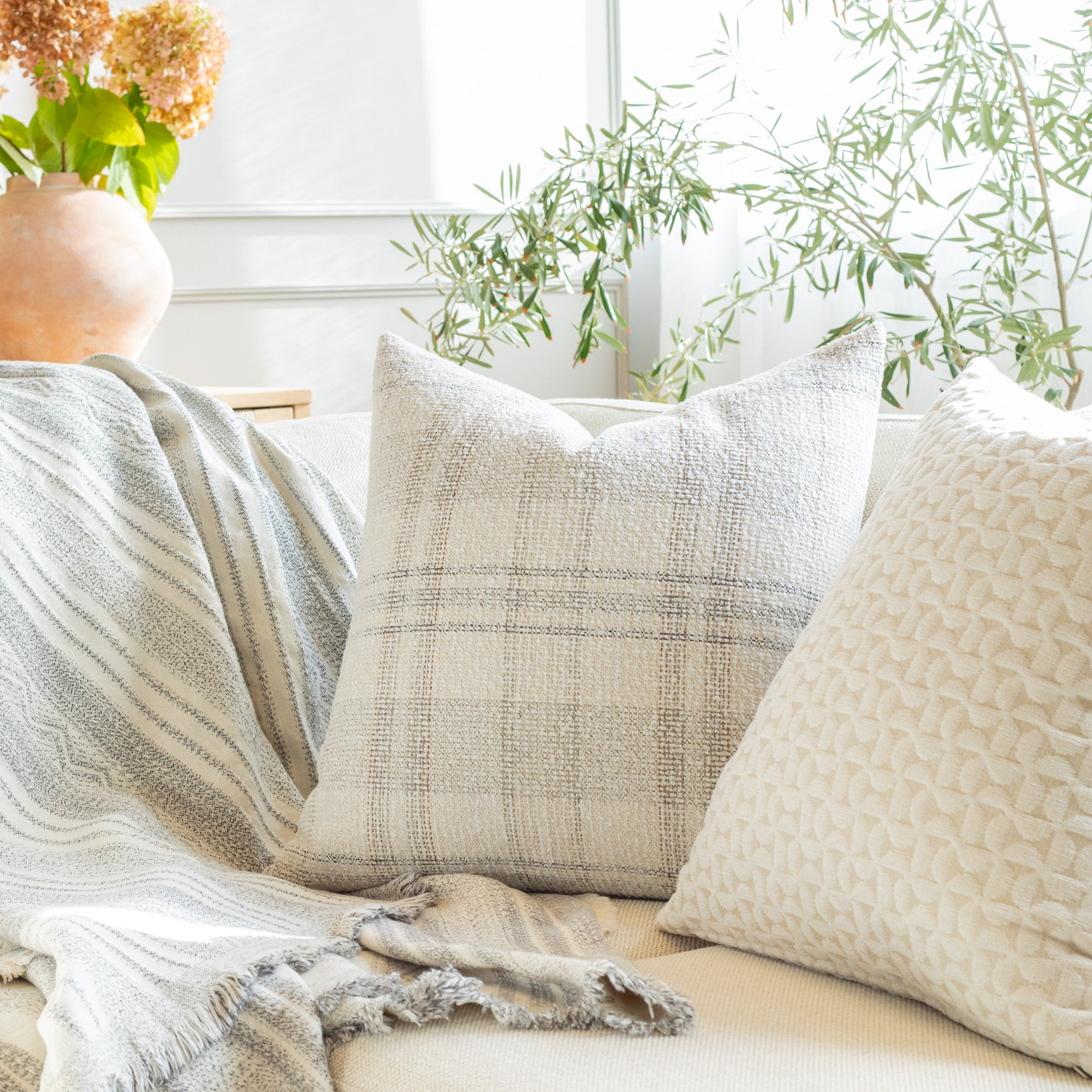 Neutral palette throw pillow and blanket from Tonic Living