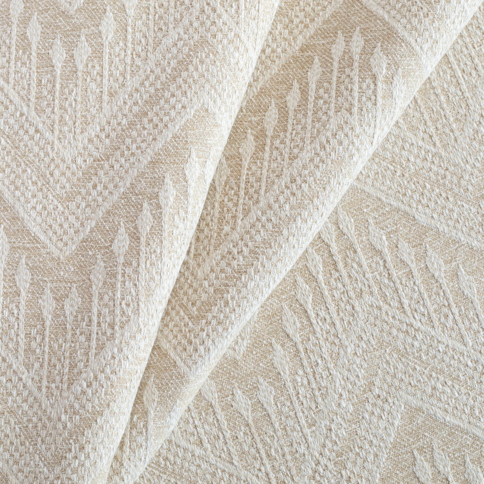 a beige upholstery fabric with a delicate woven white geometric pattern : close up view 2