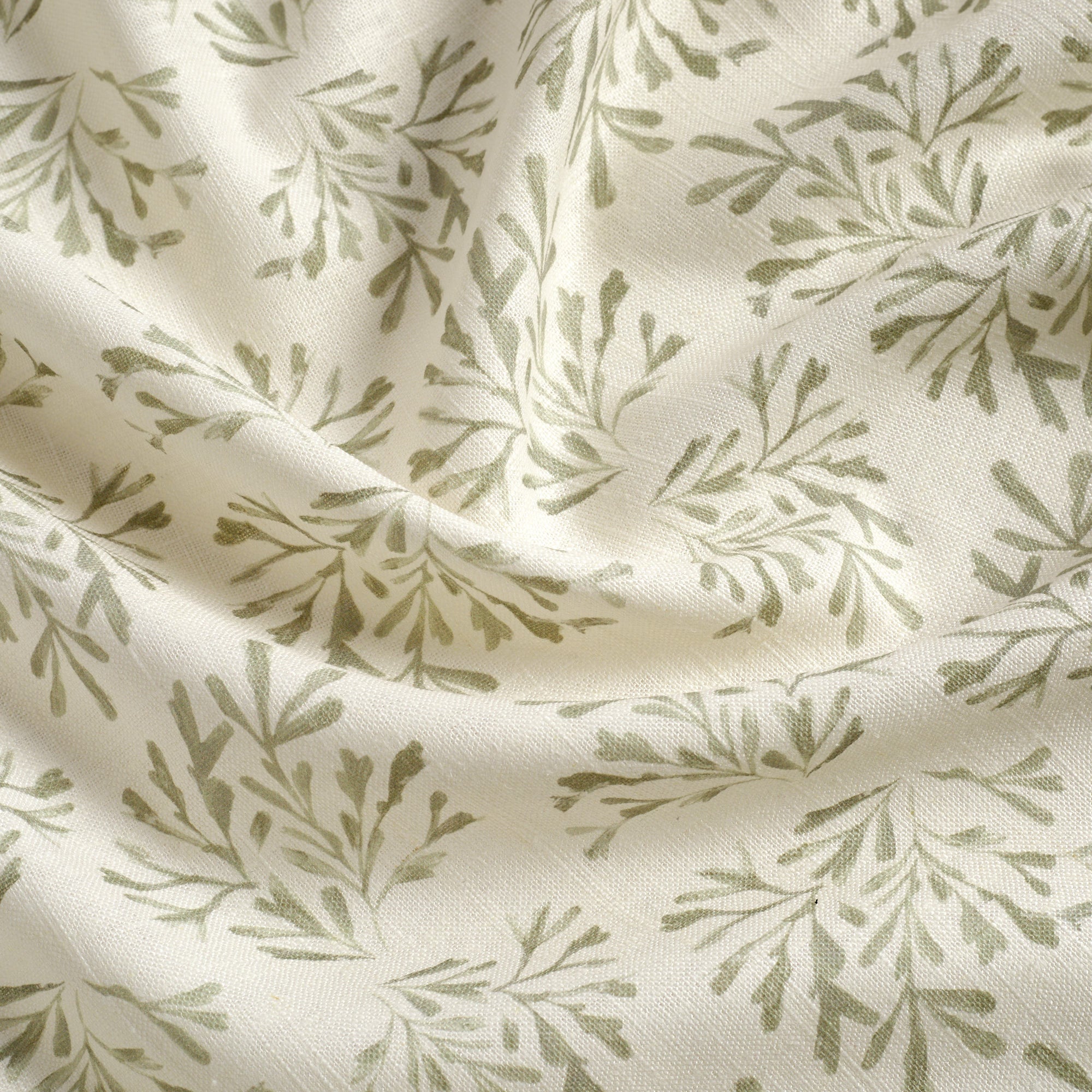 Tonic Living Juniper Sage fabric featuring a sage green and white botanical sprig print.
