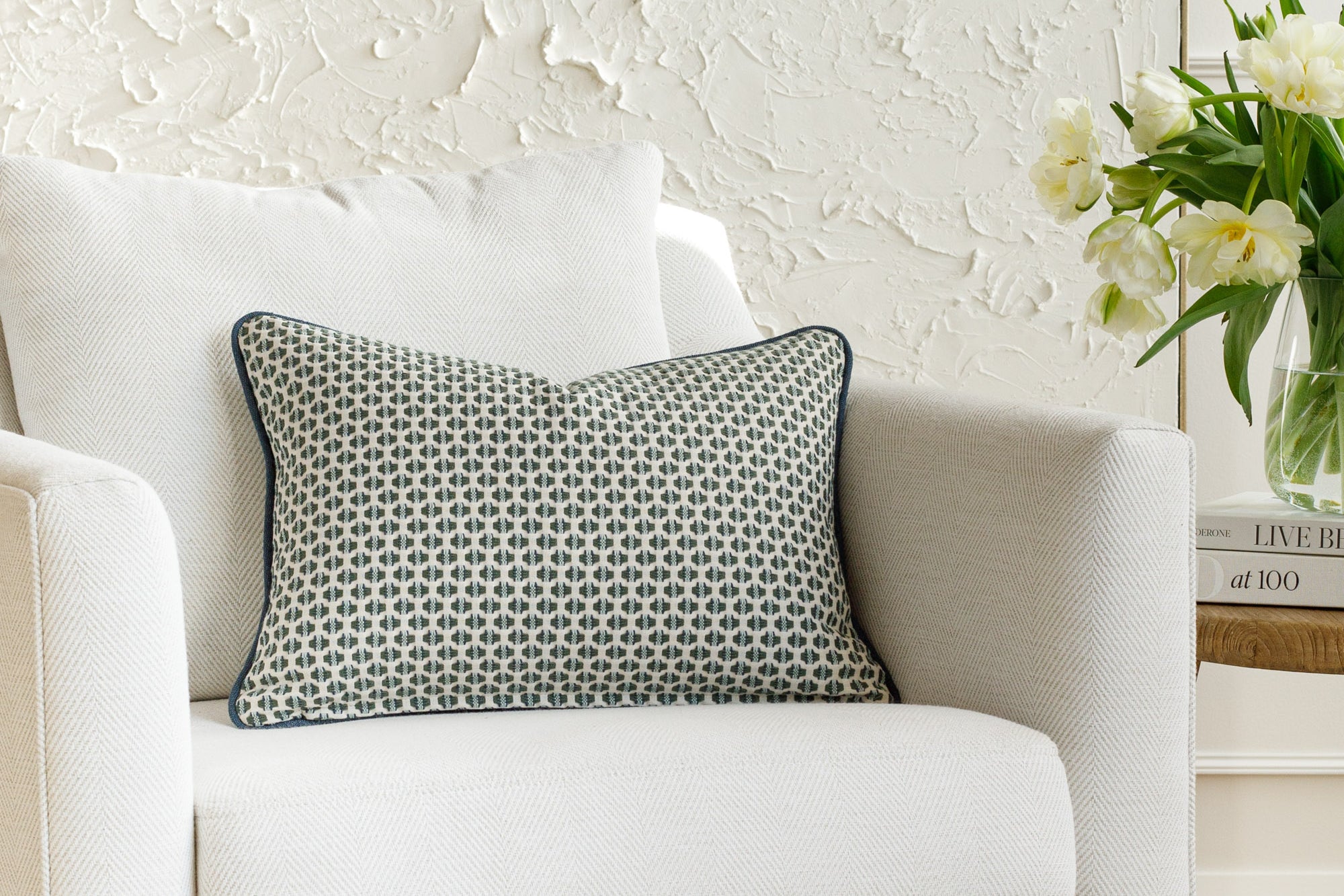 A geometric patterned pillow, styled on furniture.