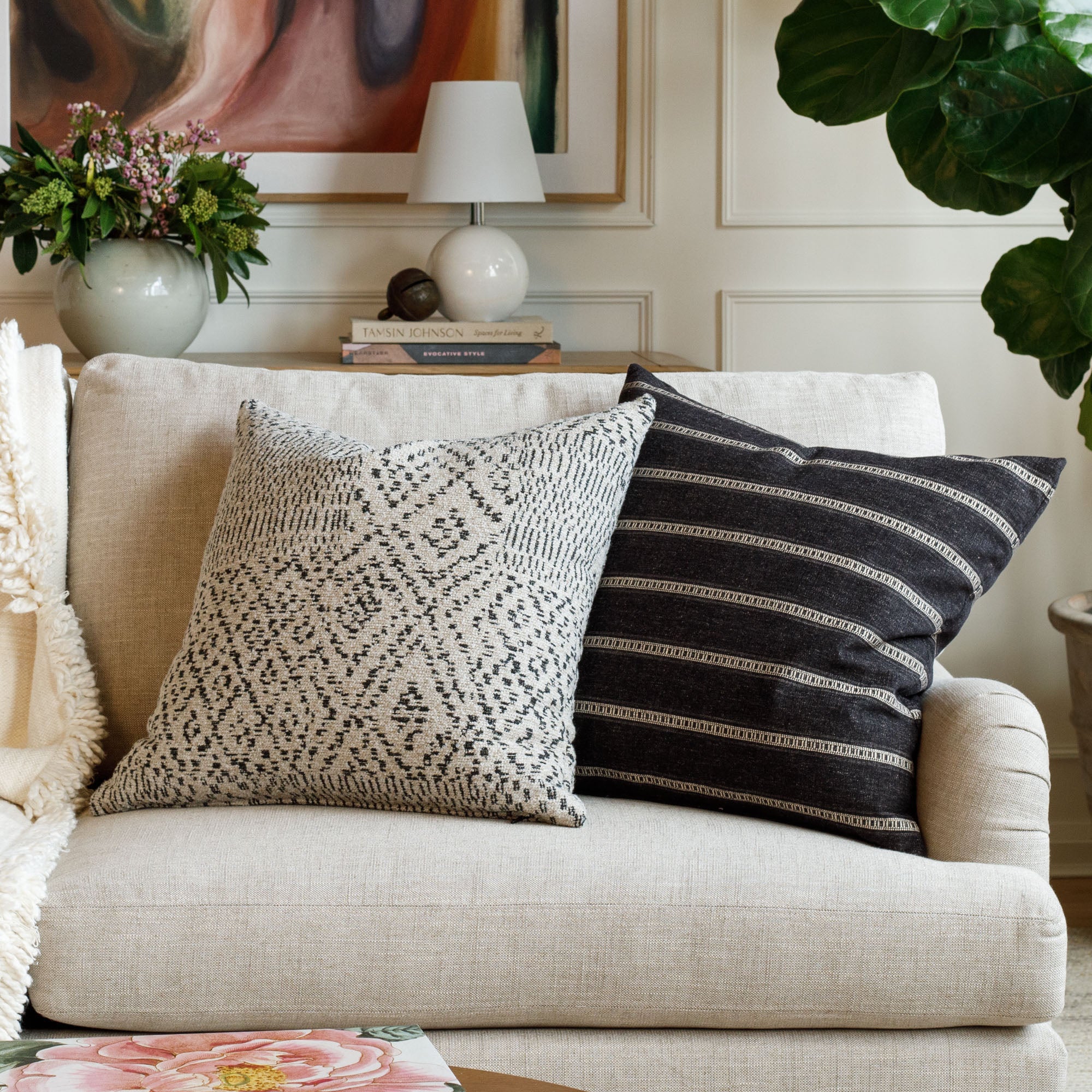 Designer throw pillows from Tonic Living, styled in a living room.