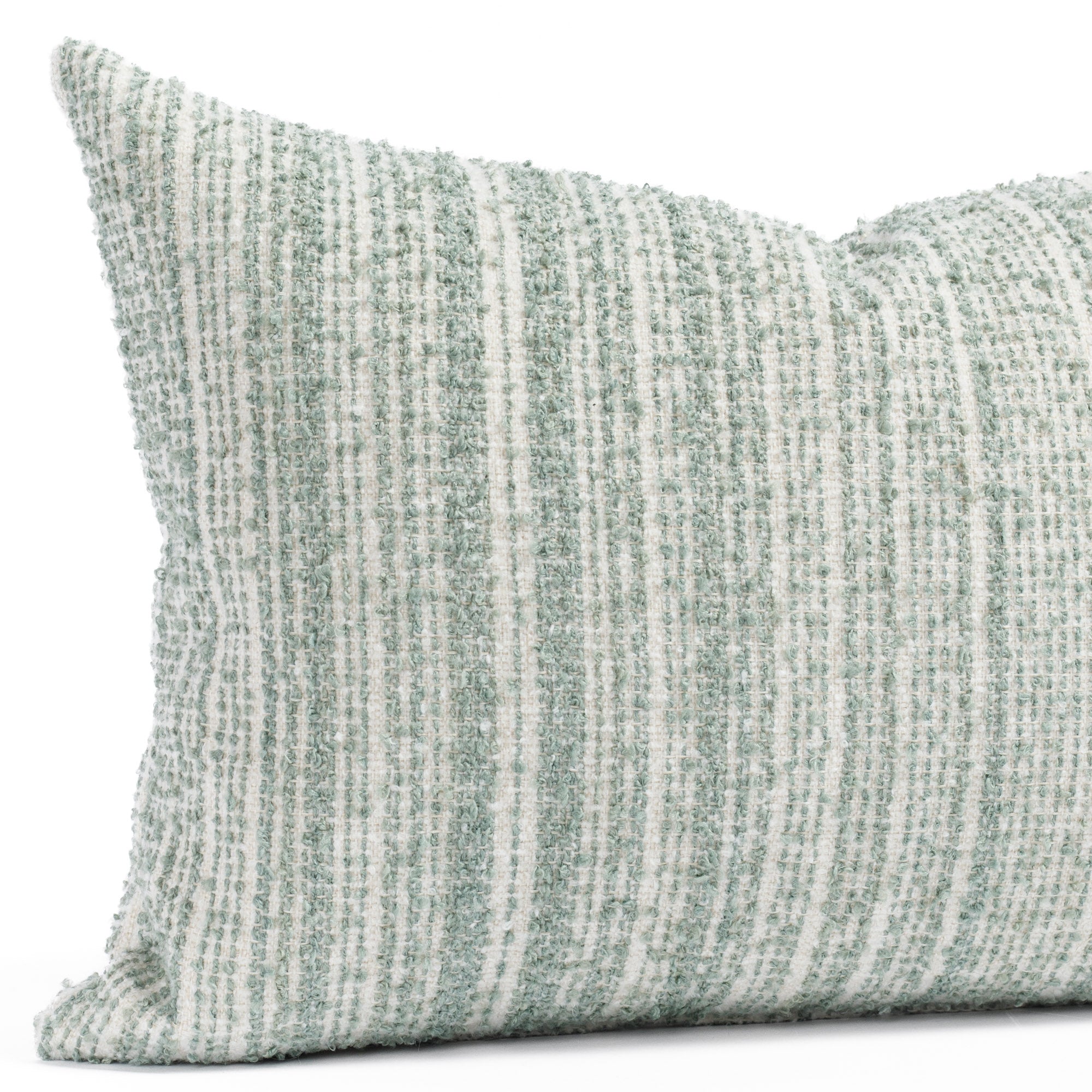 a soft white and blue green boucle striped lumbar pillow : close up view