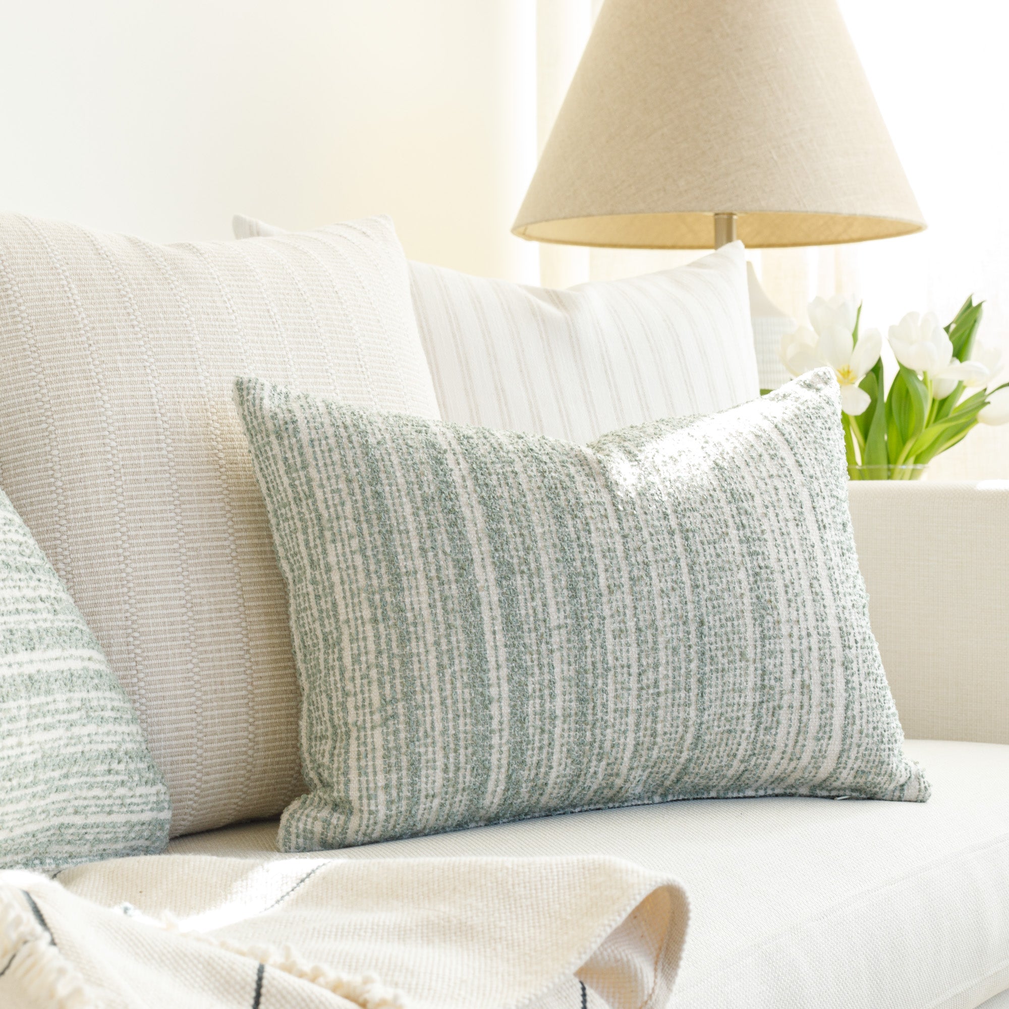 Jade and soft white throw pillows from Tonic Living