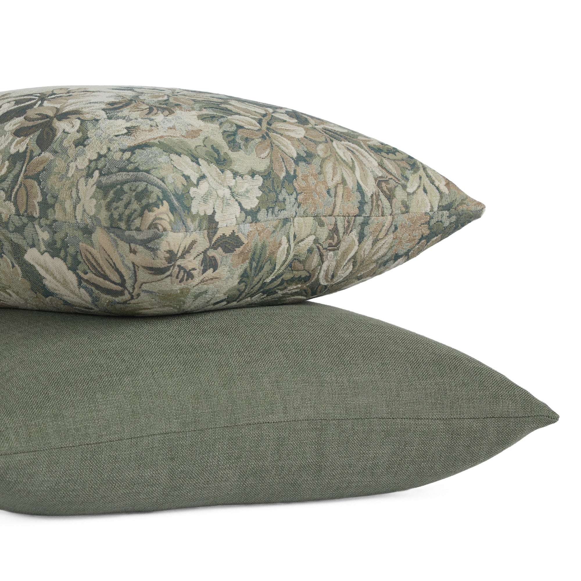 Stack of pillows featuring Loden 22x22 Pillow, Sage and Manor Tapestry 20x20 Pillow, Sage by Tonic Living — soft green tones with rich texture.