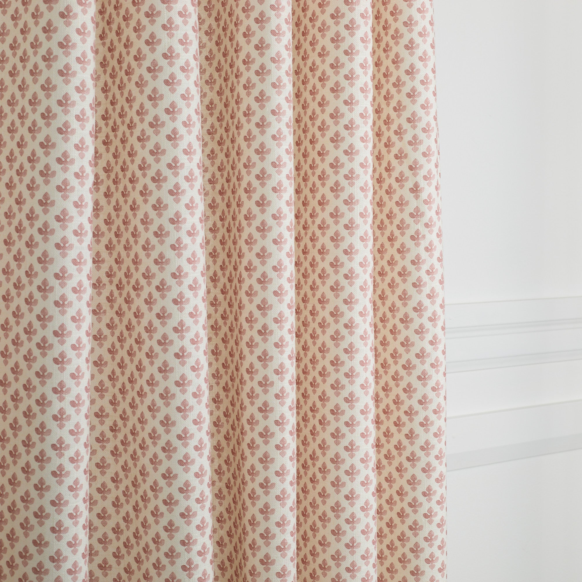 Lyra Berry curtain fabric by Tonic Living — soft linen-blend fabric with a white and dark rose floral block print.