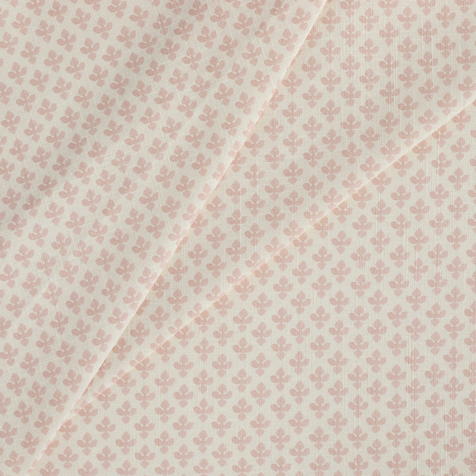 Tonic Living Lyra Fabric, Blush — linen-blend drapery fabric with a white and light pink floral block print design.