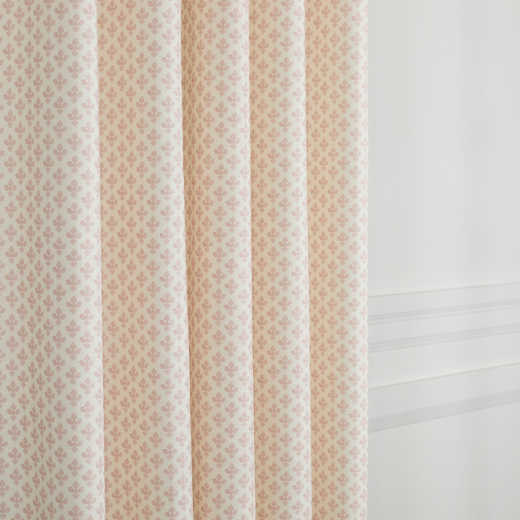 Lyra Blush curtain fabric by Tonic Living — soft linen-blend fabric with a white and baby pink floral block print.