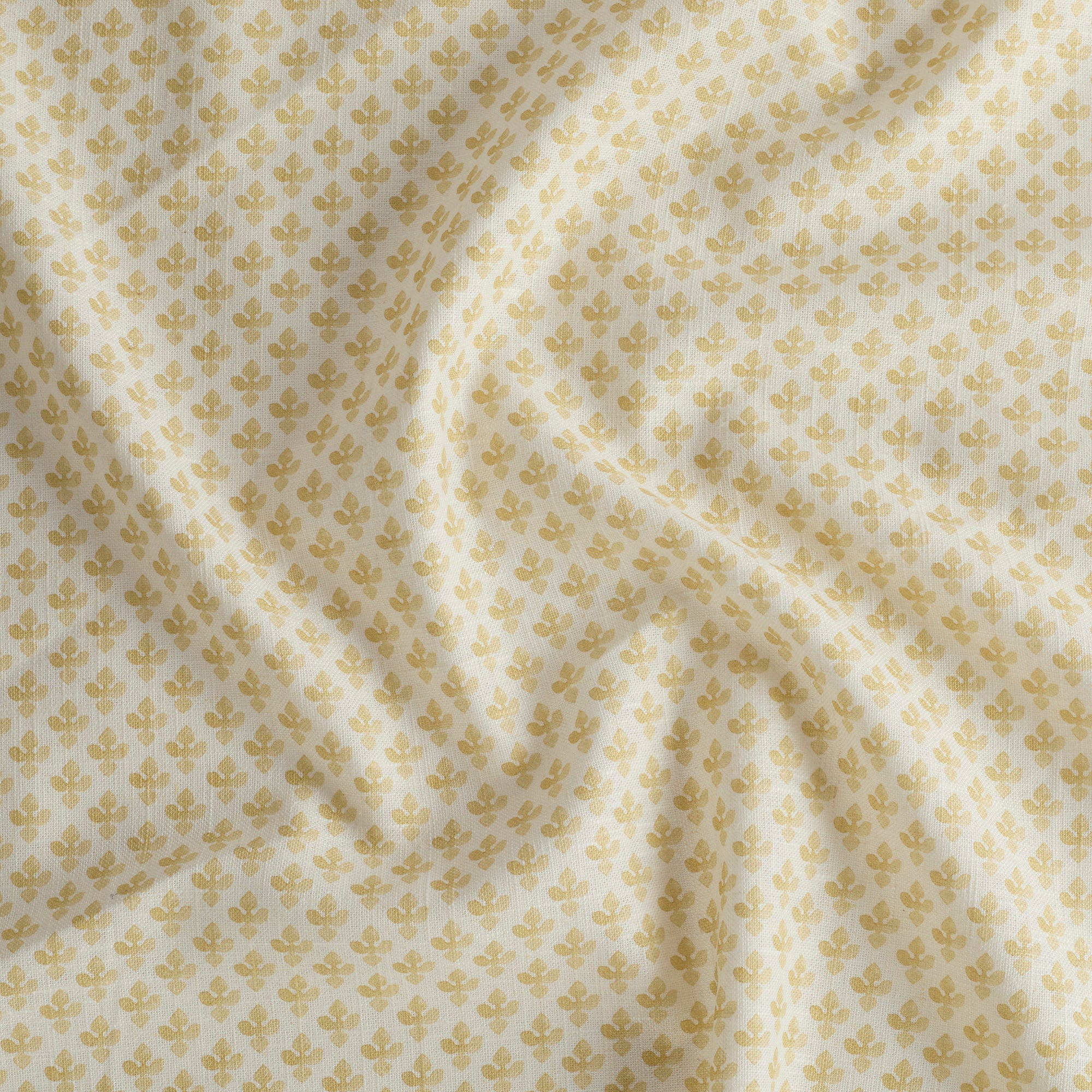 Lyra Butter Yellow high-quality drapery fabric by Tonic Living — white and yellow floral block print on soft linen-blend material.